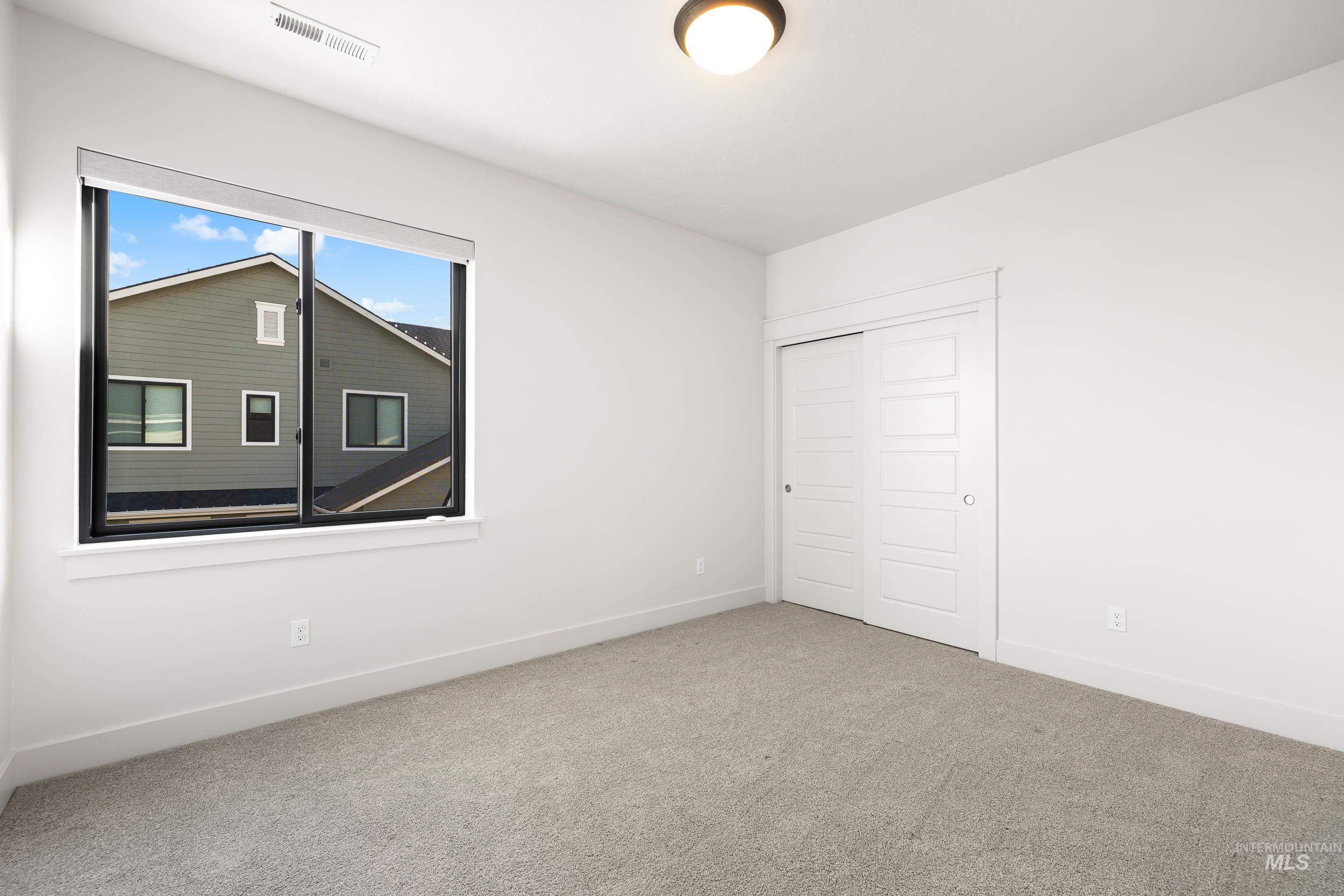 Unfurnished bedroom with a closet and carpet