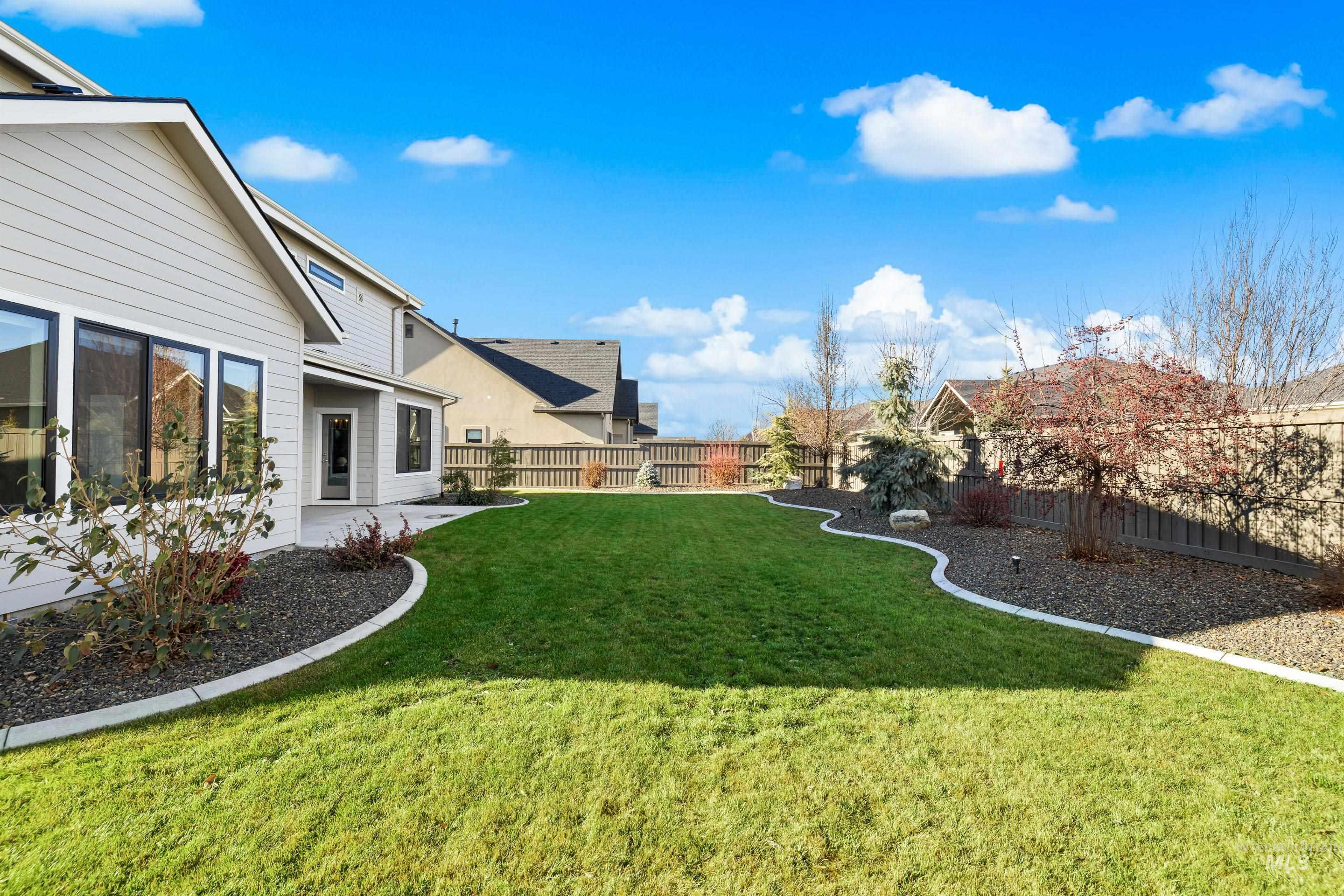 Fenced backyard with a patio area and a residential view