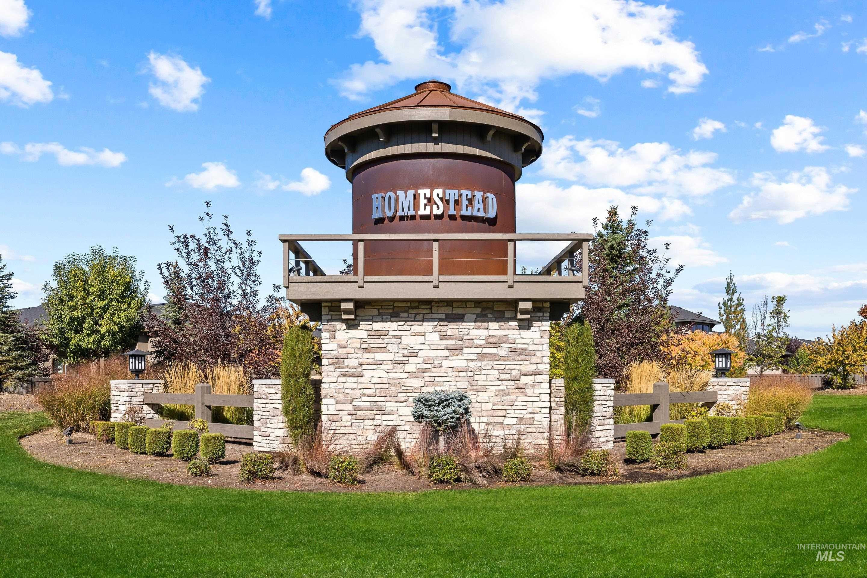 Community sign featuring a yard and a gazebo