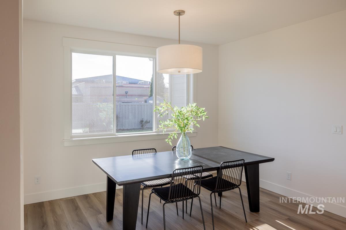 Dining space with wood finished floors and baseboards
