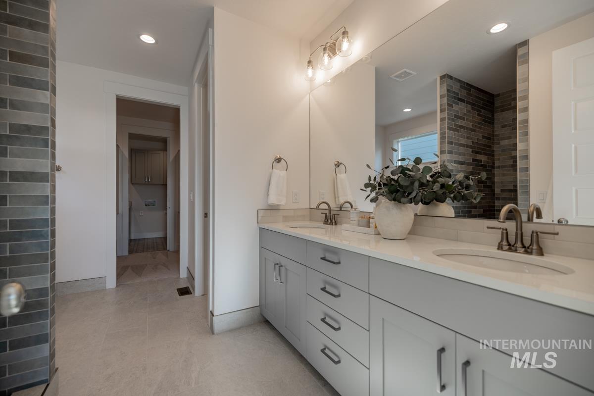 Full bath featuring double vanity and recessed lighting