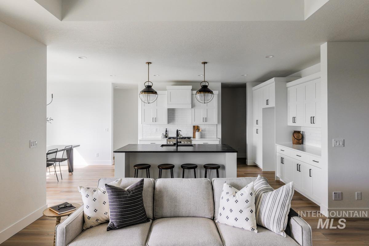 Living area featuring dark wood finished floors and recessed lighting