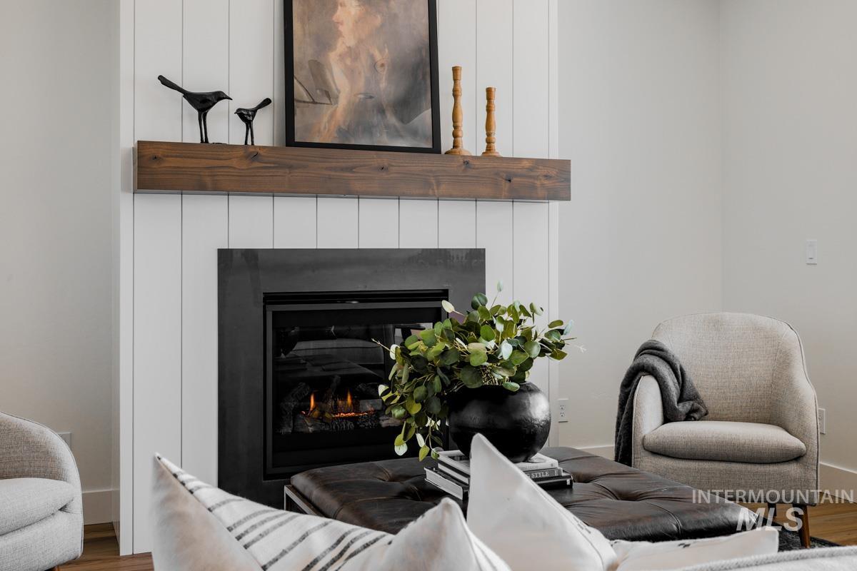 Detailed view of a glass covered fireplace and wood finished floors