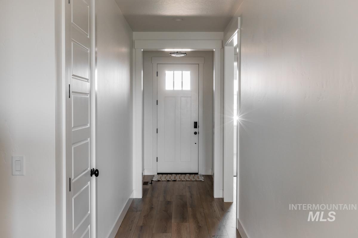 Entryway with wood finished floors and baseboards