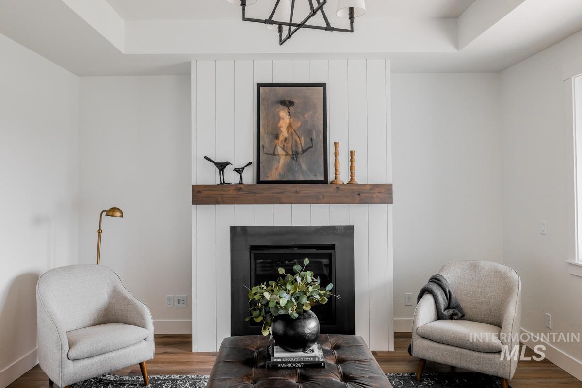 Sitting room featuring a fireplace and wood finished floors