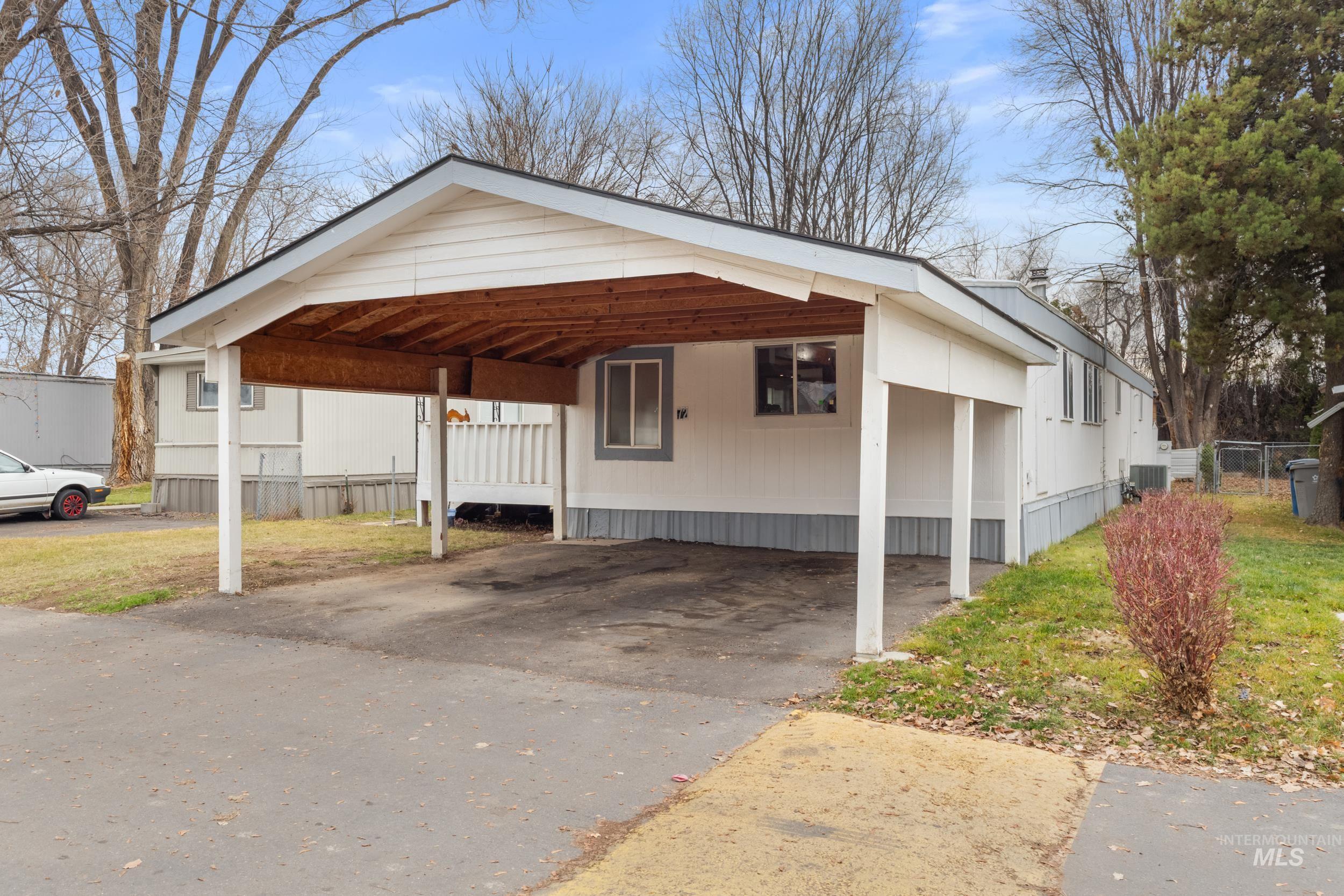 View of home's exterior featuring driveway and a porch