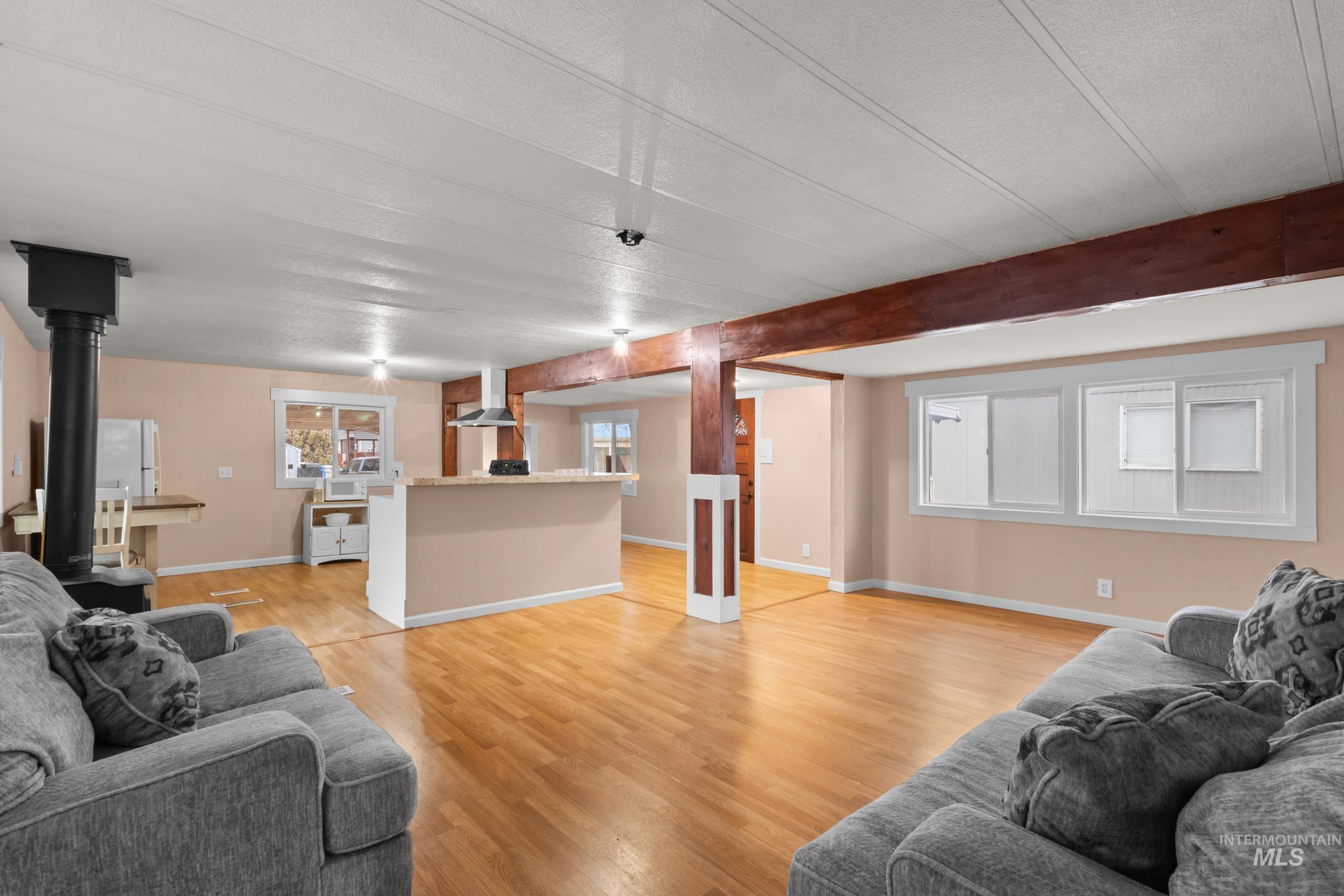 Living room featuring light wood-style floors and baseboards
