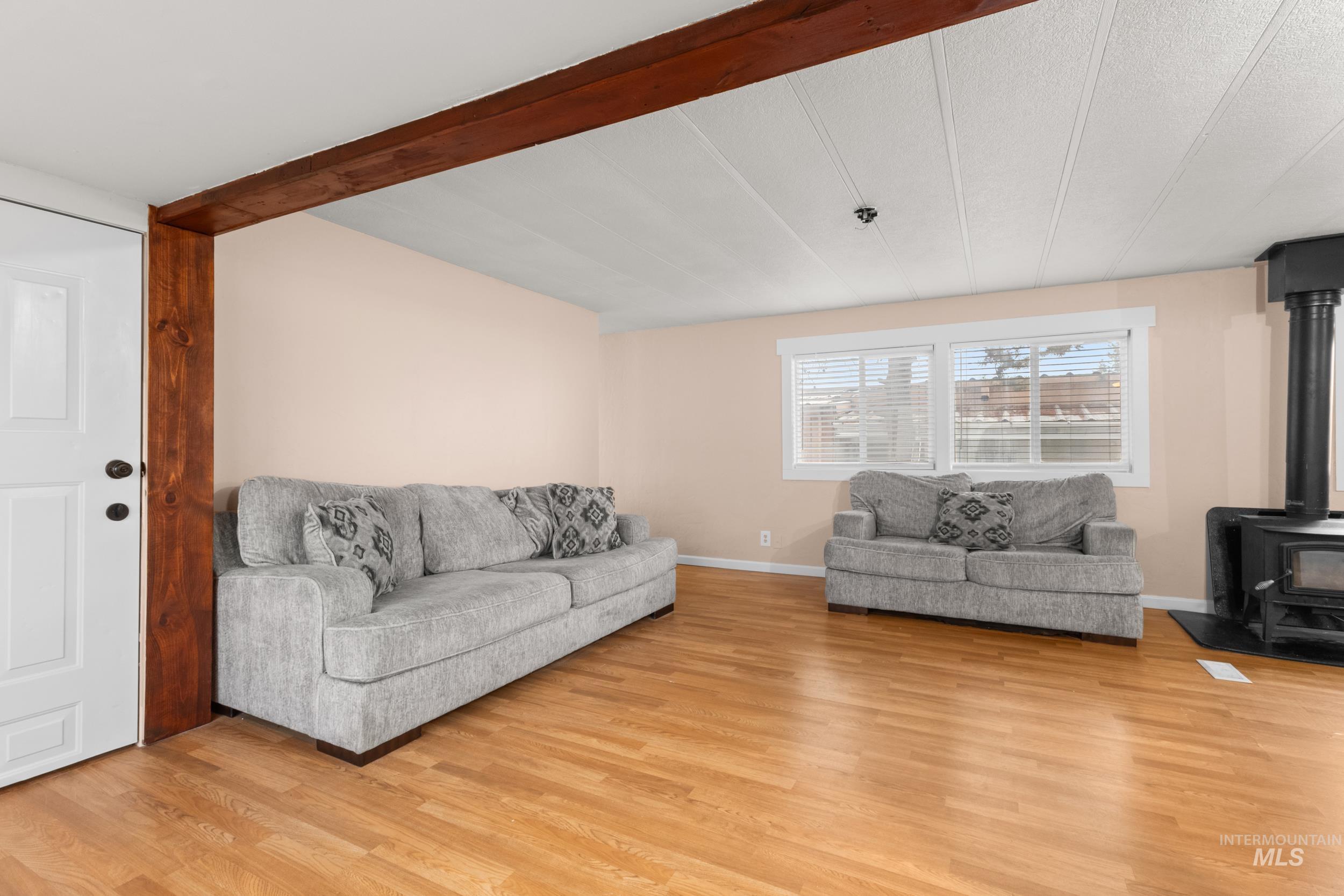 Living area featuring a wood stove and light wood-style floors
