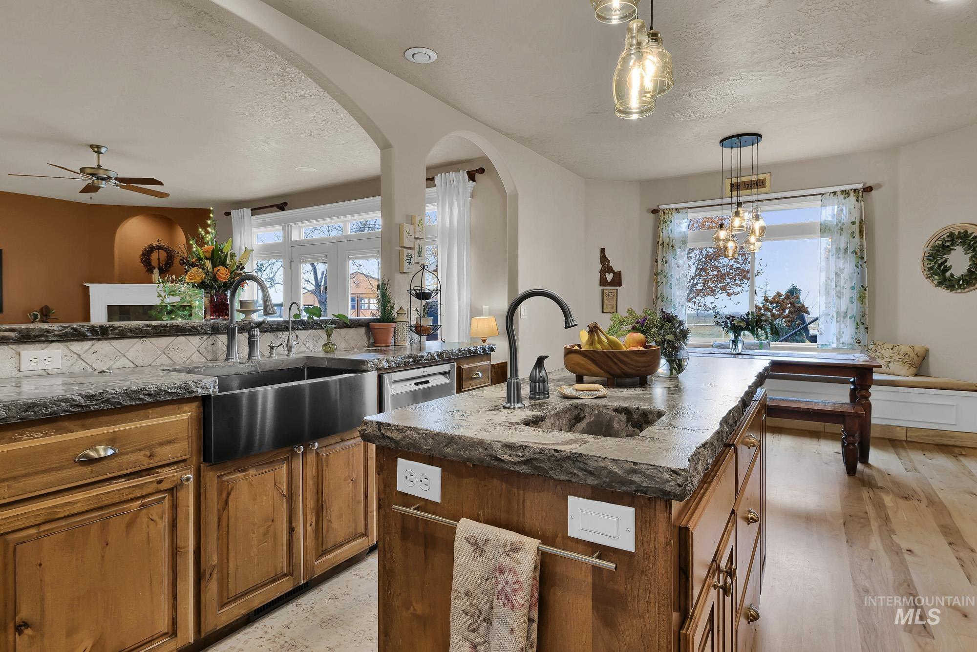 Kitchen includes a center island with veggie sink, Rustic Alder cabinets, Newer concrete counters and refinished Maple flooring