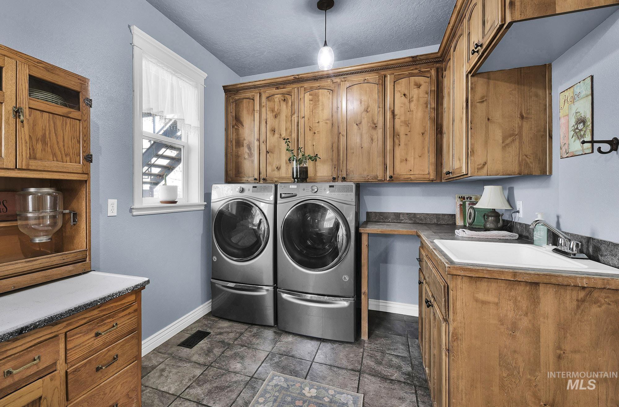 Laundry area featuring built in cabinets -folding space and a deep utility sink