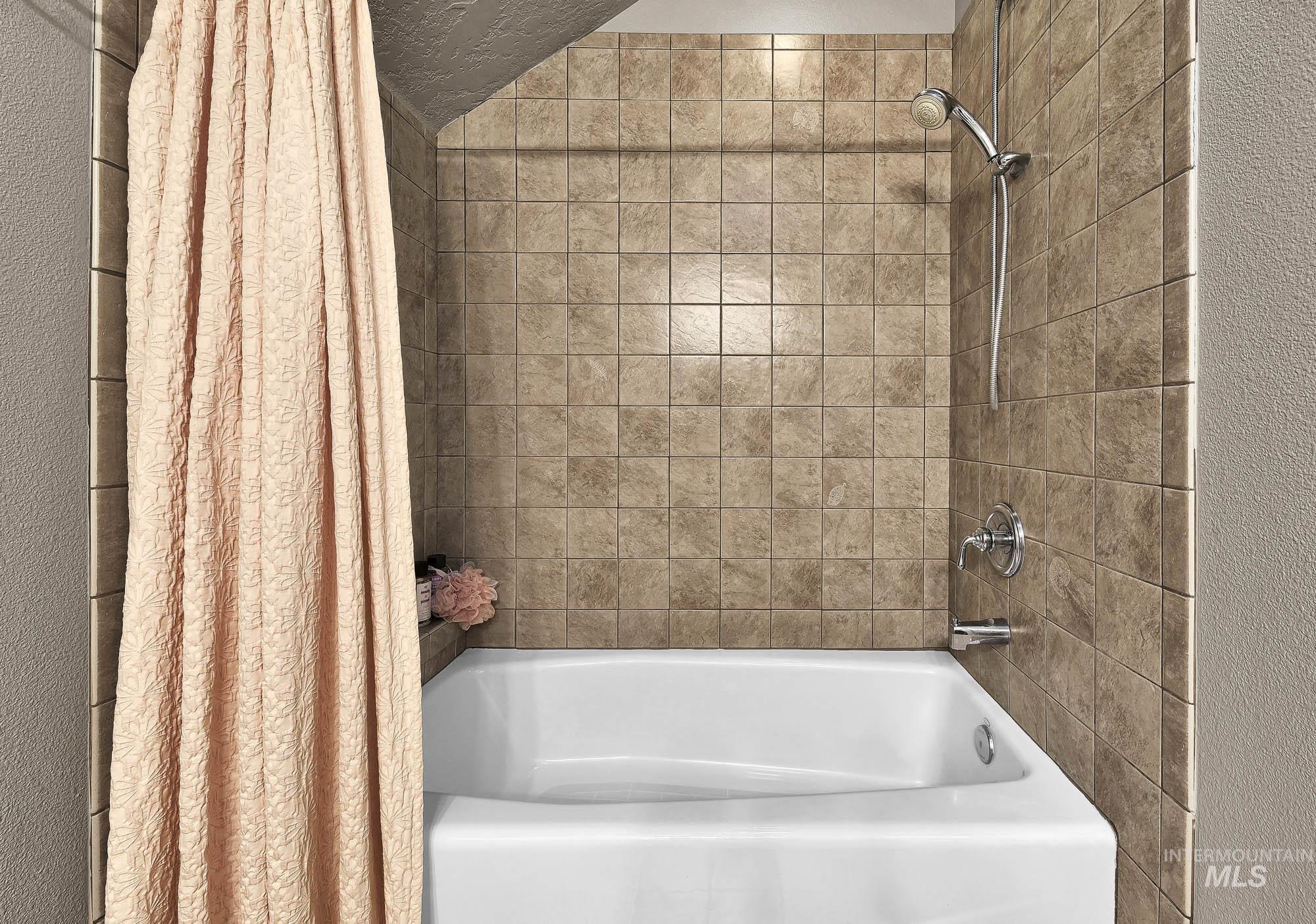 Full bathroom with shower / bath combination with skylight