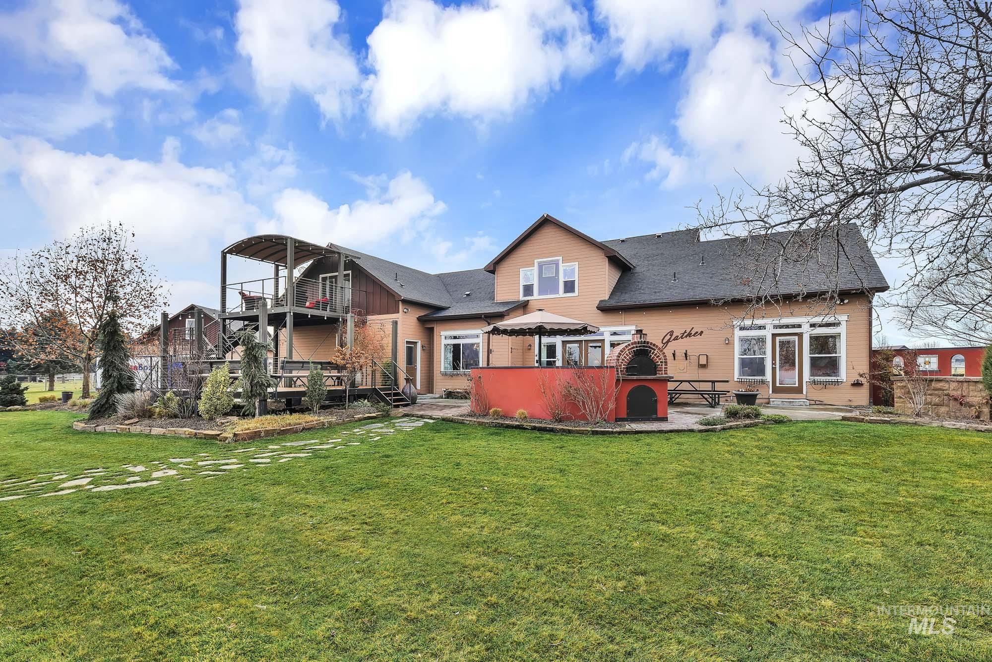 Back of house featuring the expansive yard and a patio gathering area