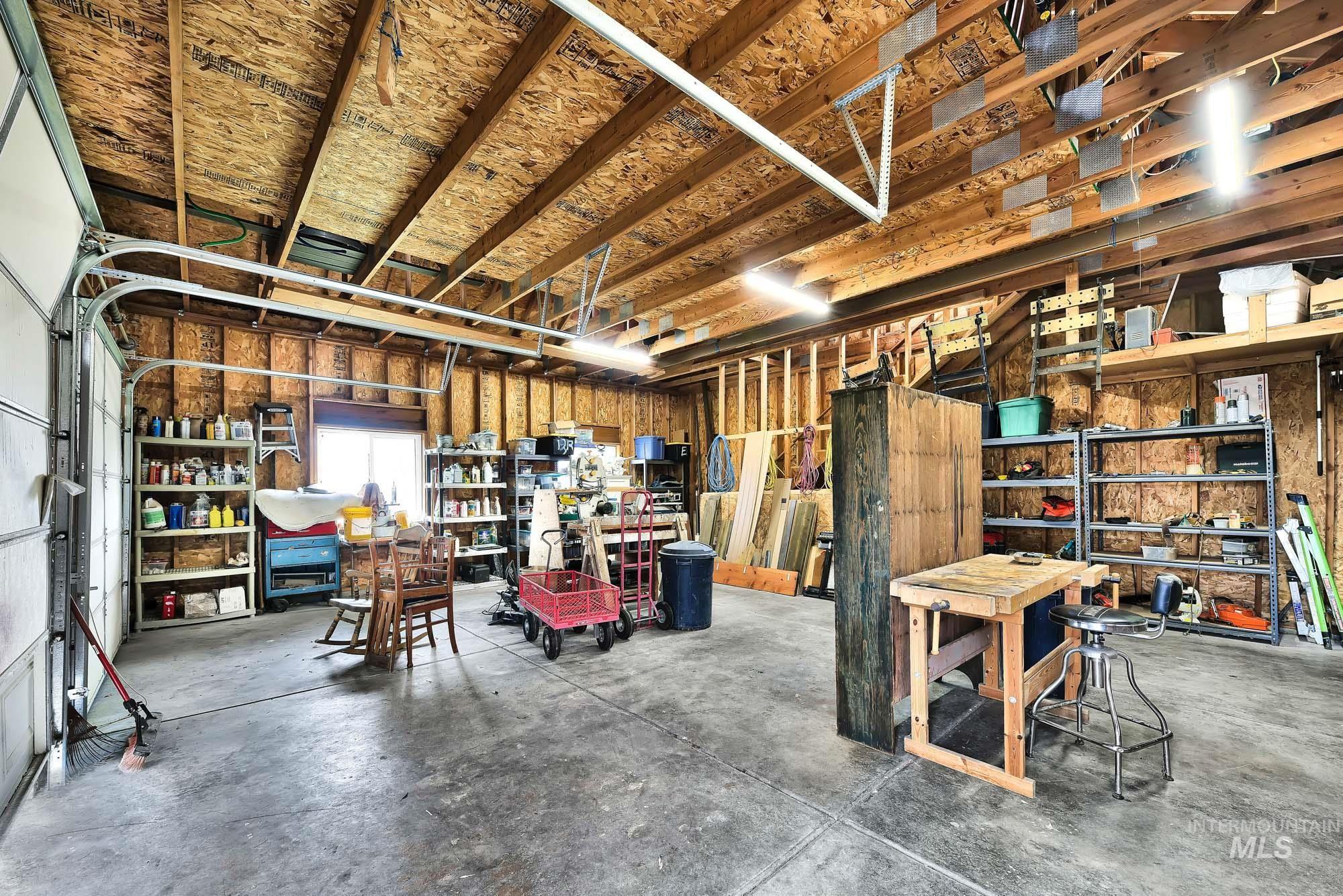 View of garage/shop with vaulted ceilings