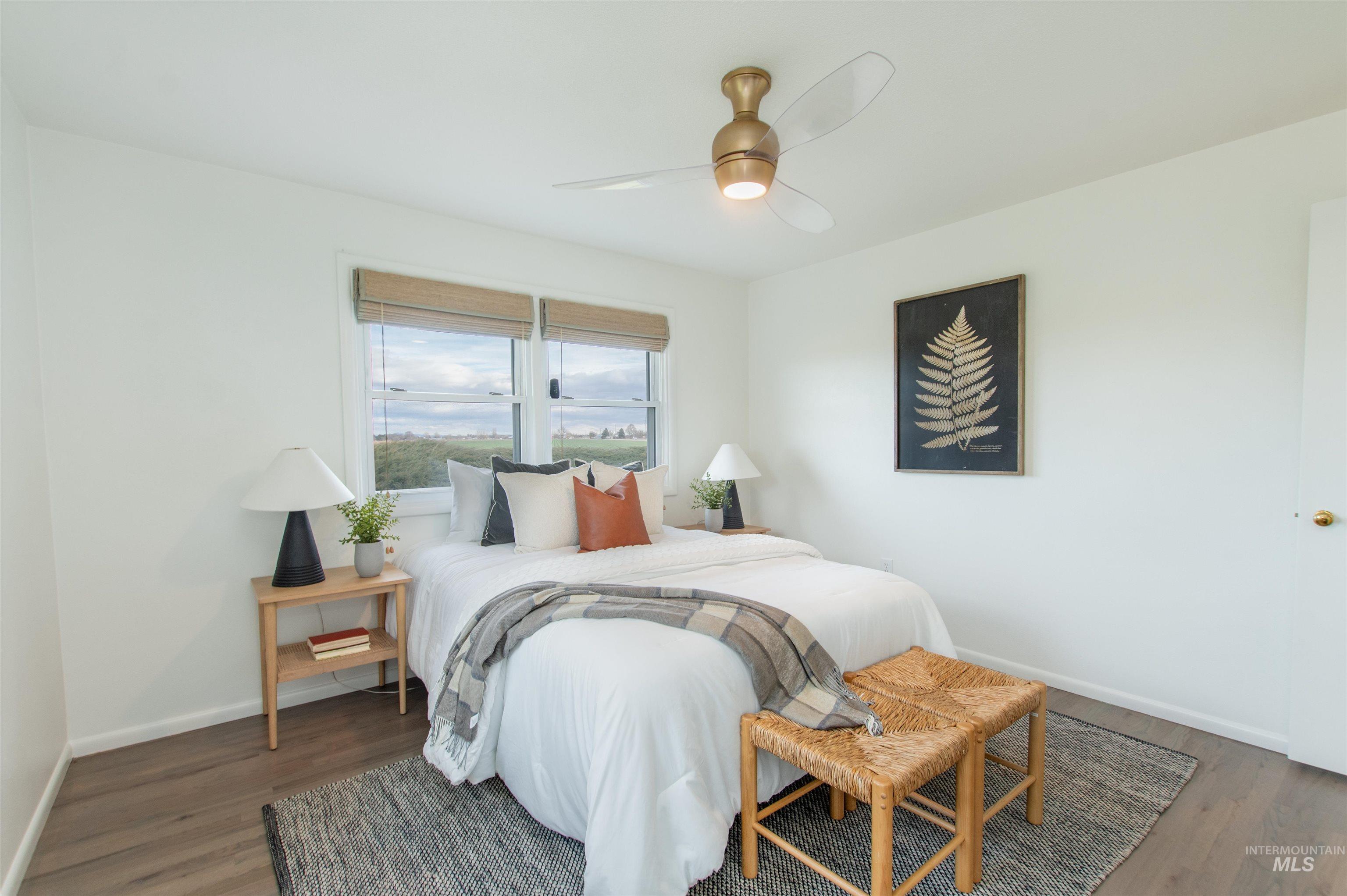 Bedroom with a ceiling fan and wood finished floors