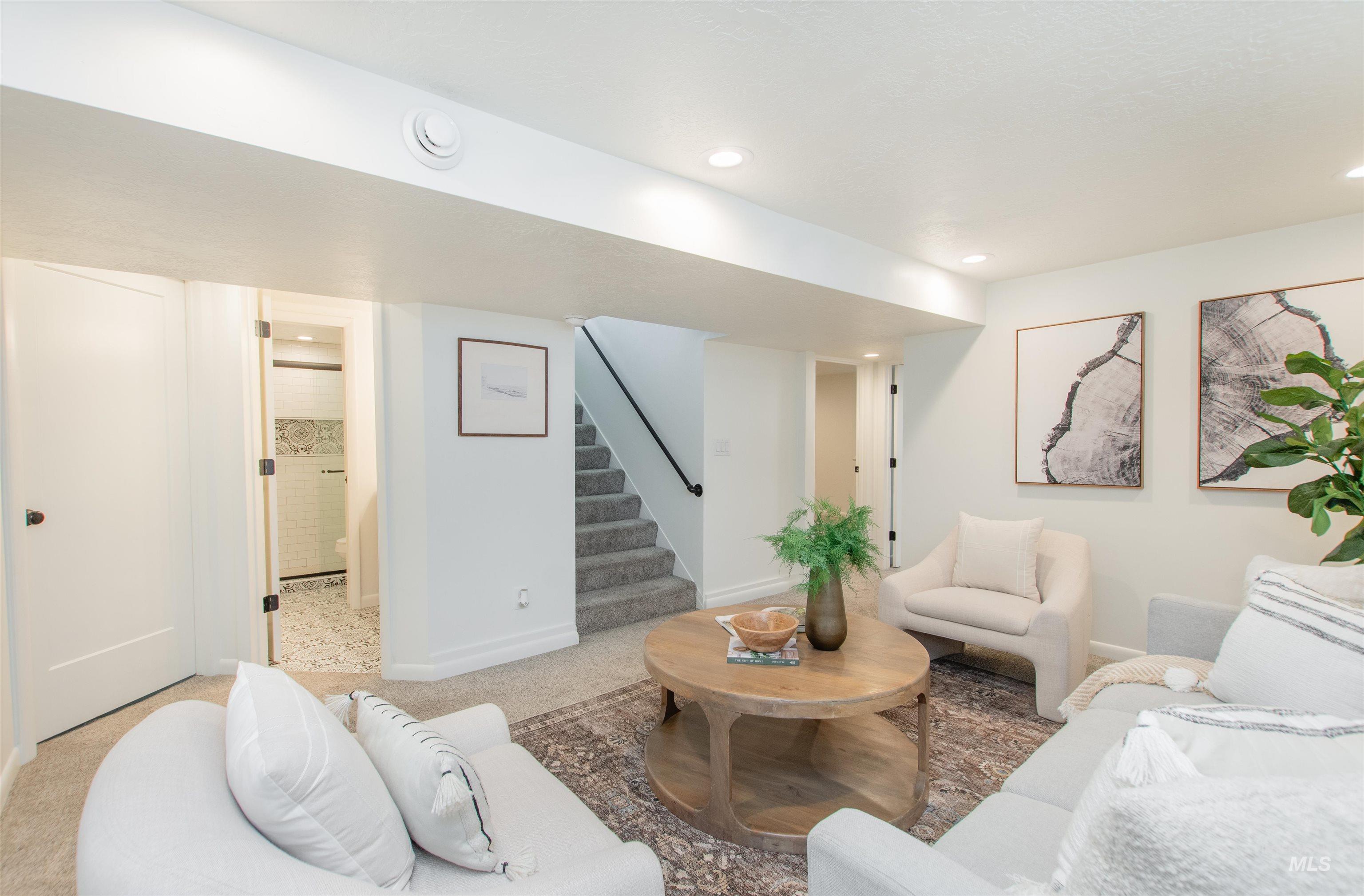 Living room with stairs, carpet floors, and recessed lighting
