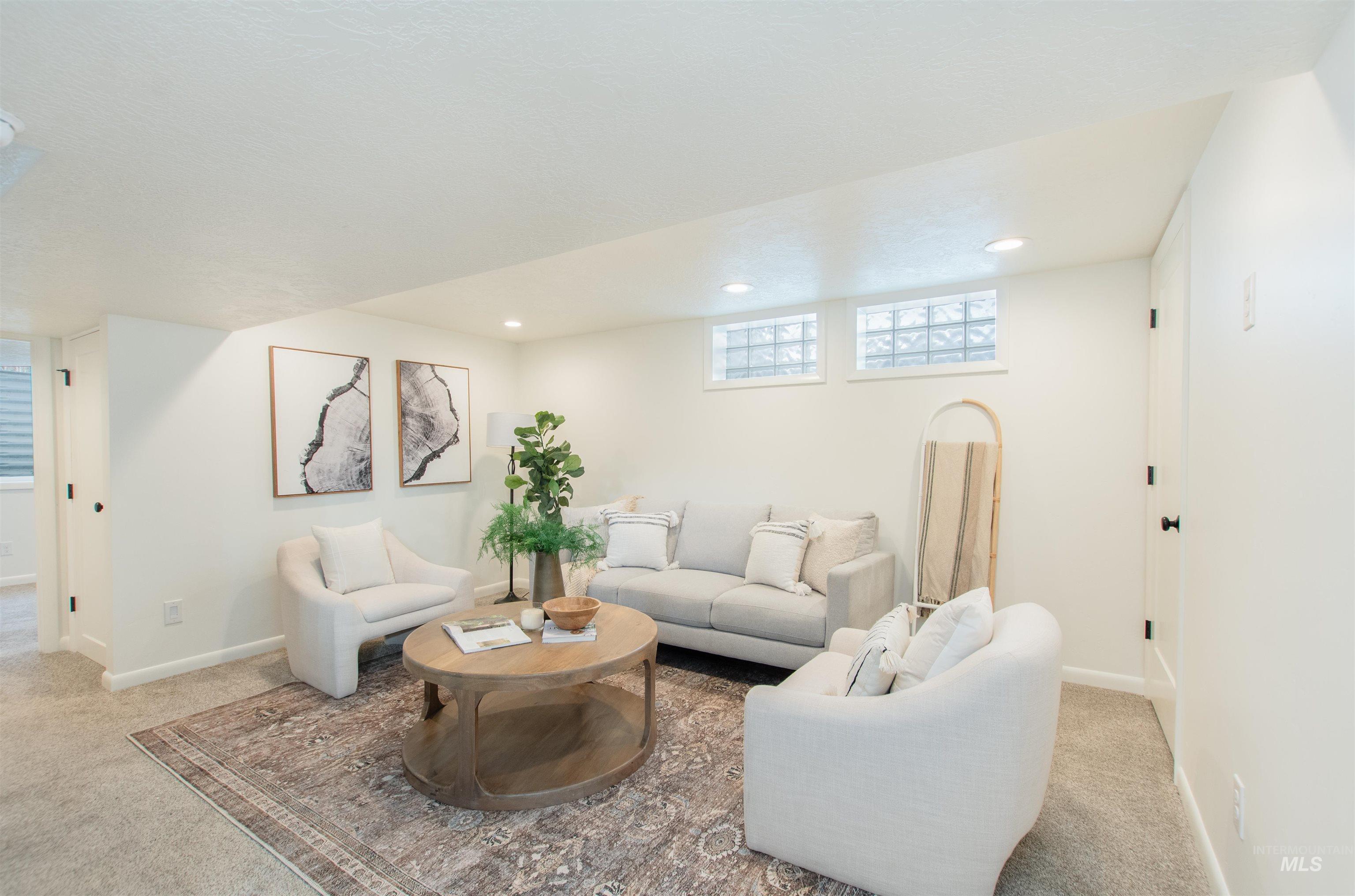 Living room with light carpet and recessed lighting