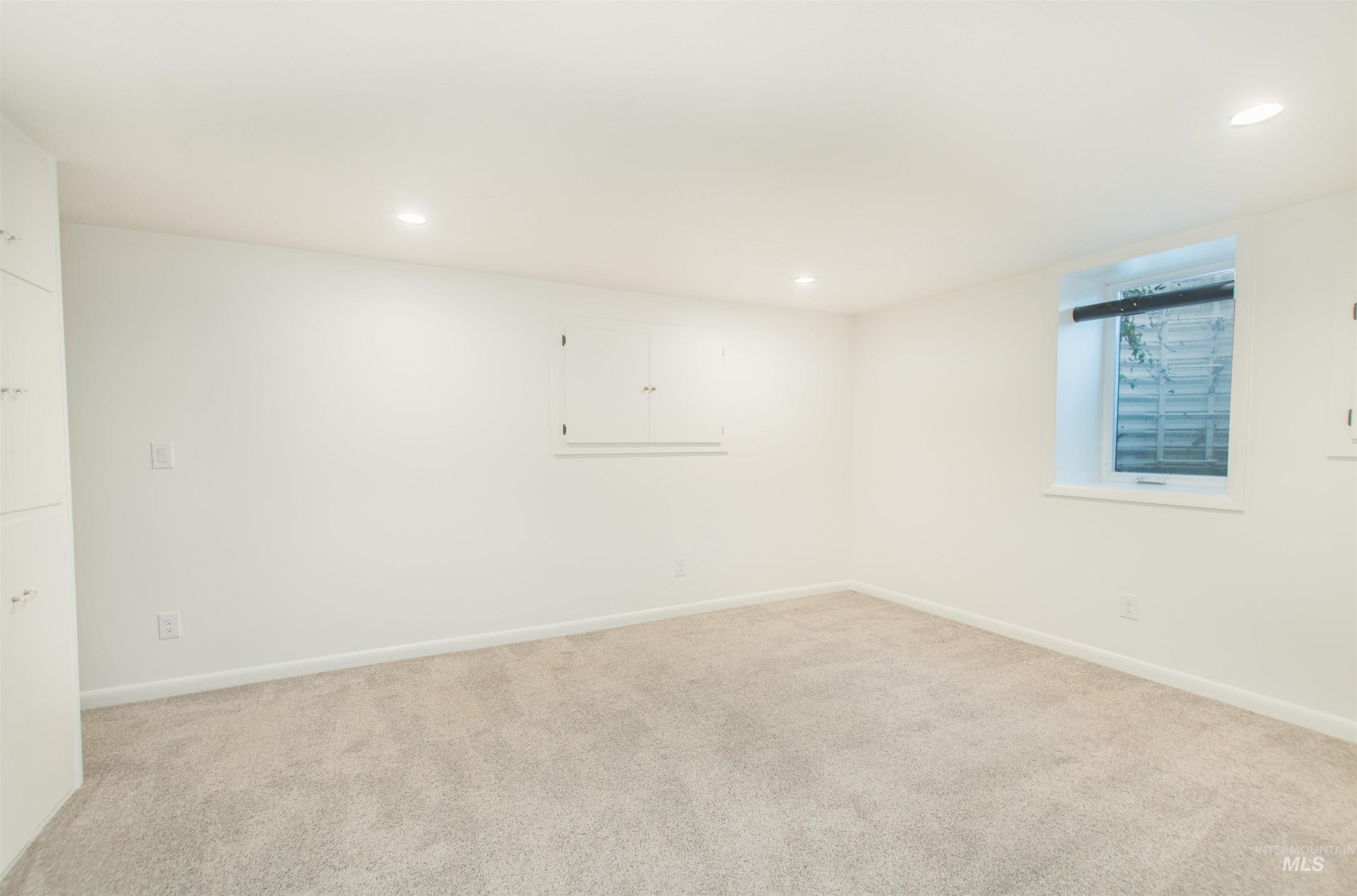 Carpeted spare room with recessed lighting