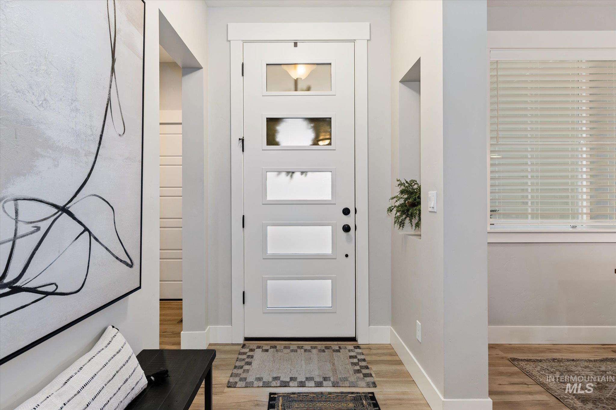 Entrance foyer featuring light wood-style floors and baseboards