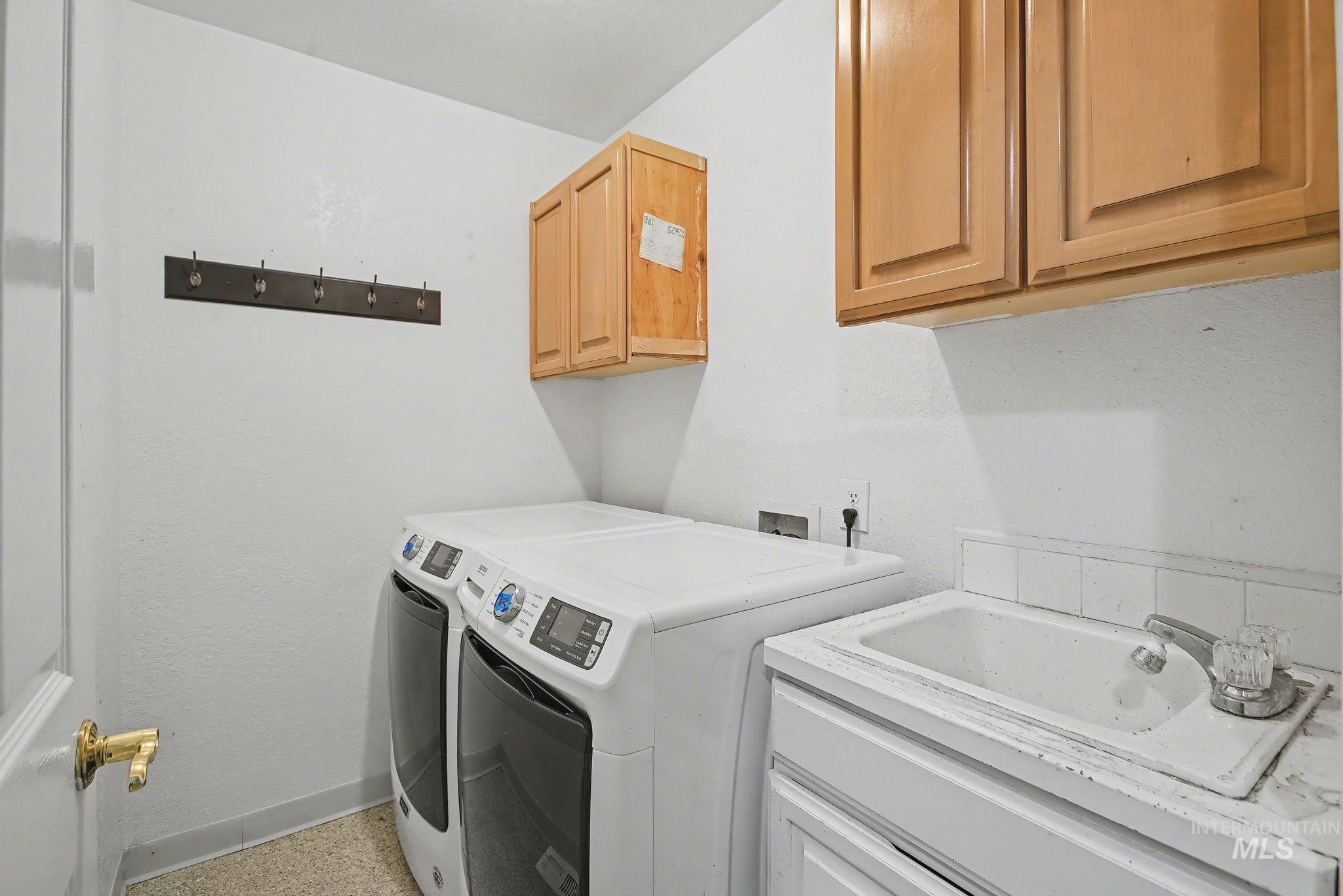 Laundry area with washing machine and clothes dryer and cabinet space