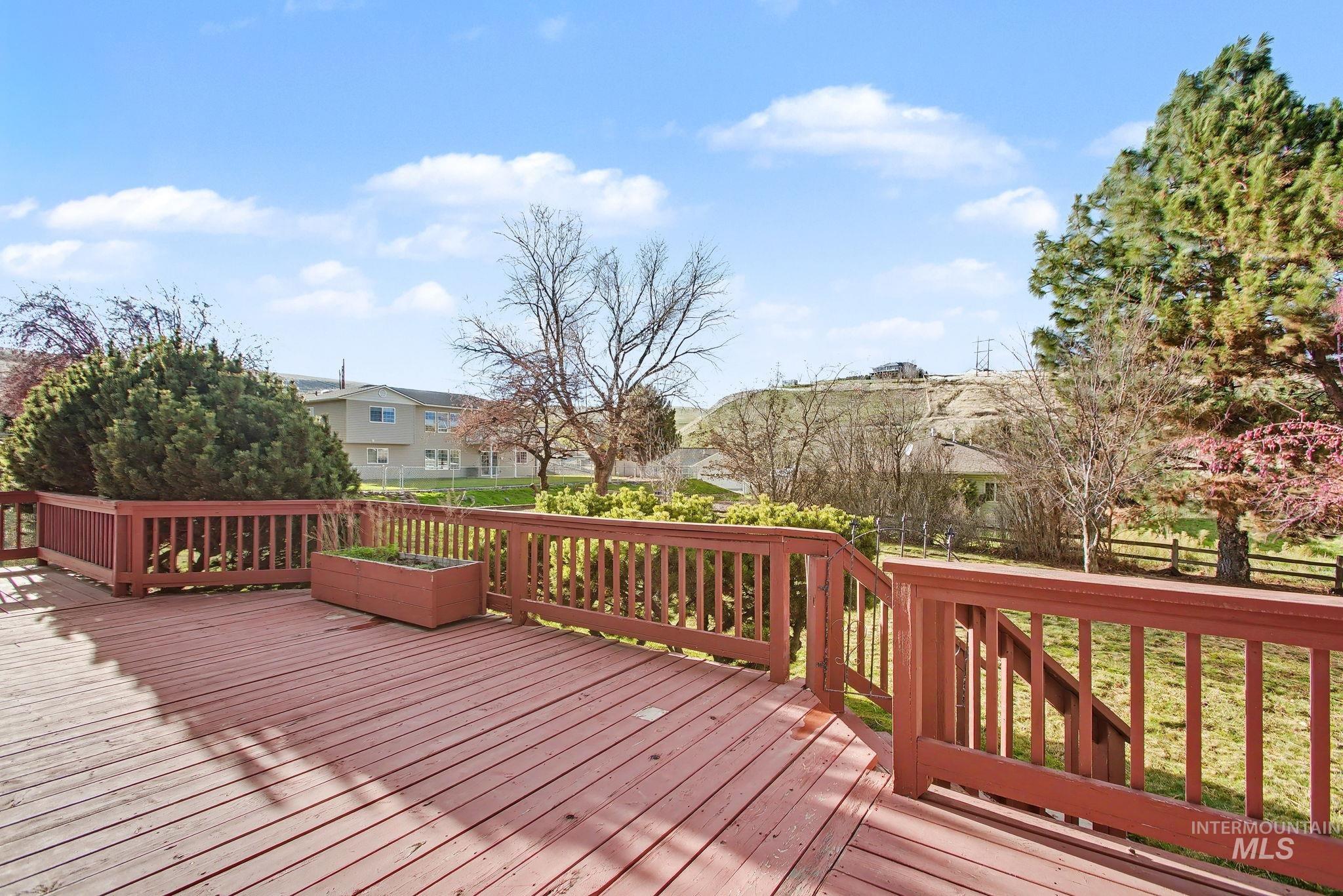 Wooden terrace featuring a residential view