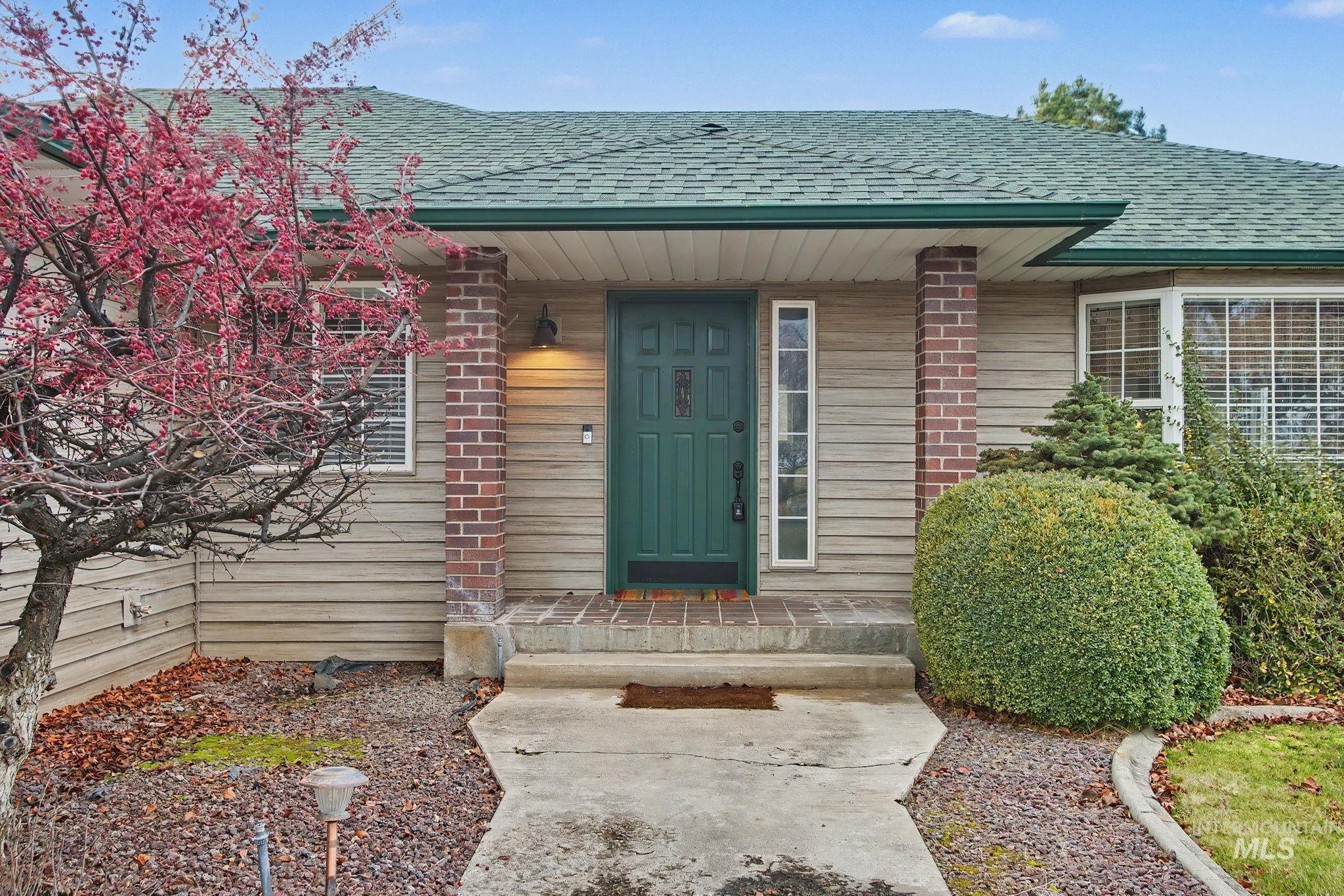 View of exterior entry featuring roof with shingles