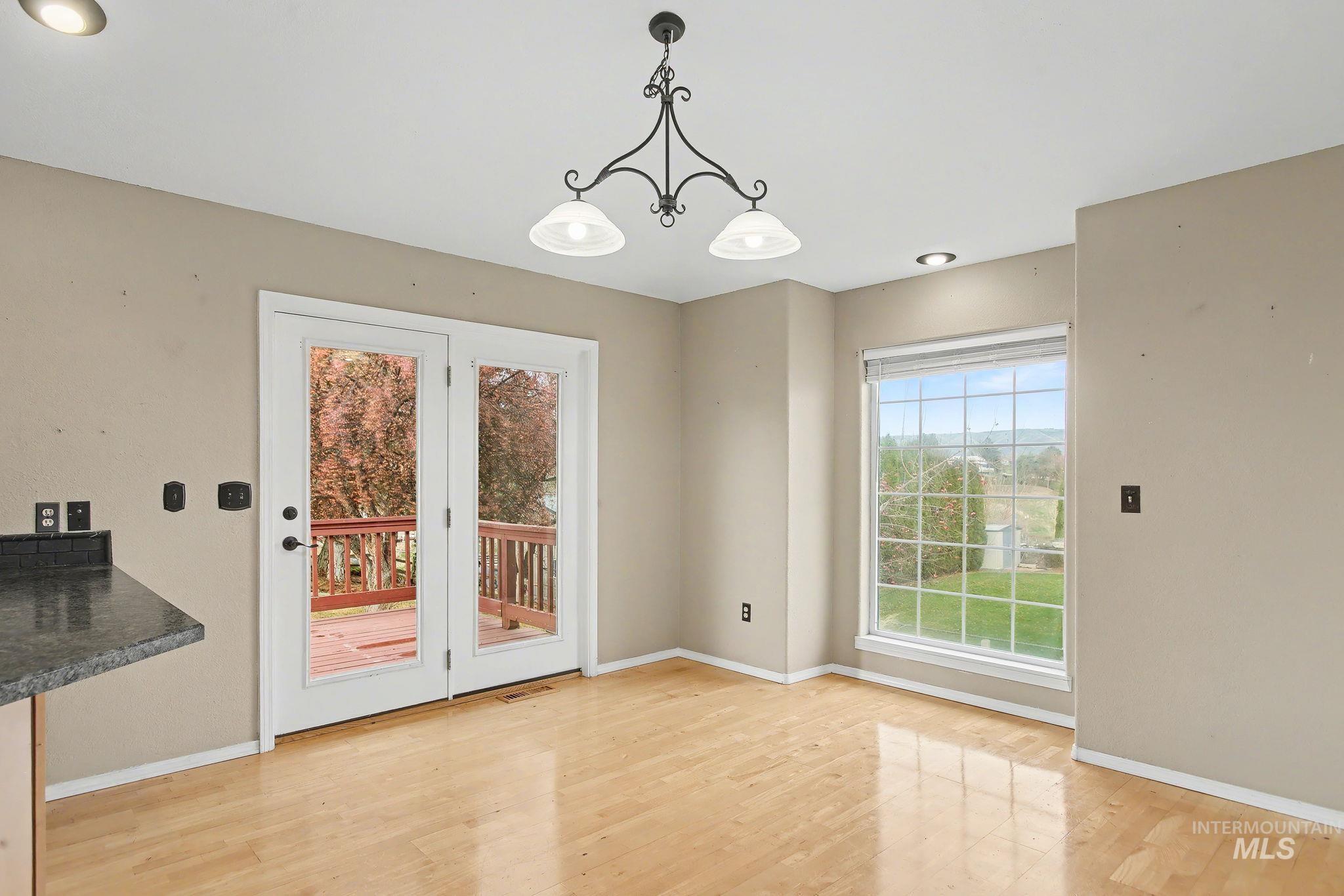 Unfurnished dining area featuring recessed lighting, light wood-type flooring, and a chandelier