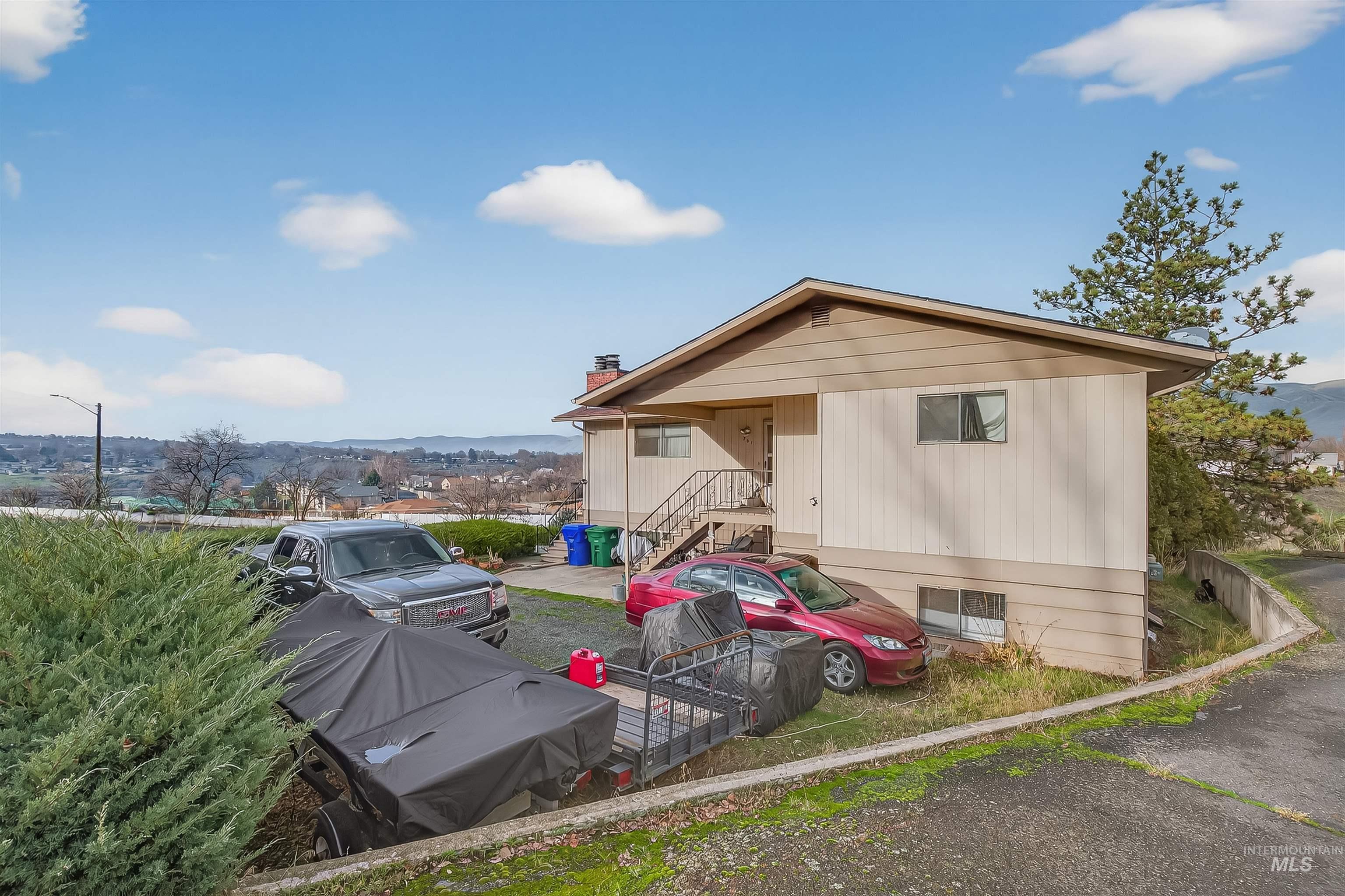 Rear view of property with a chimney and a mountain view