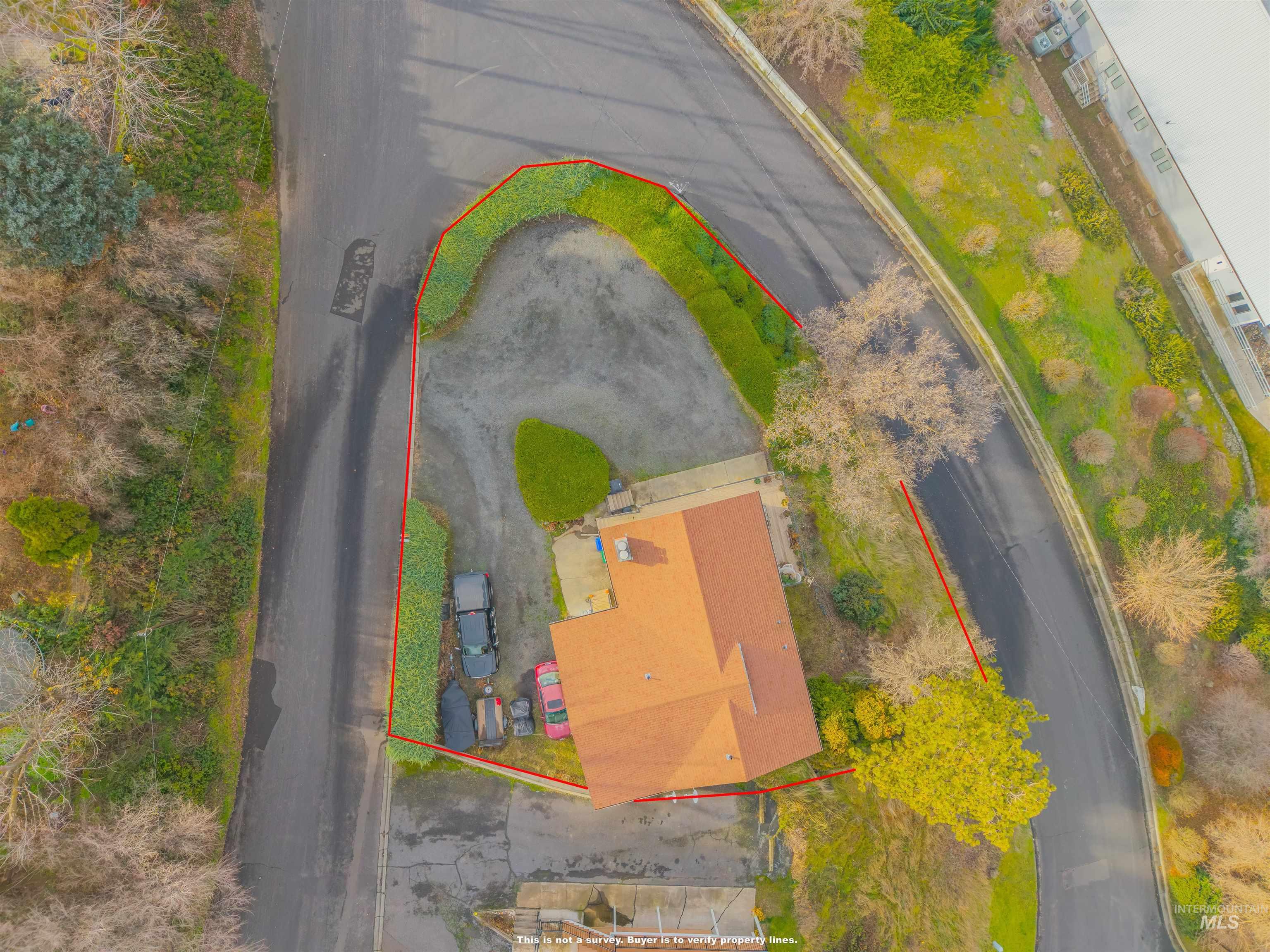 Aerial view of property and surrounding area featuring property parcel outlined