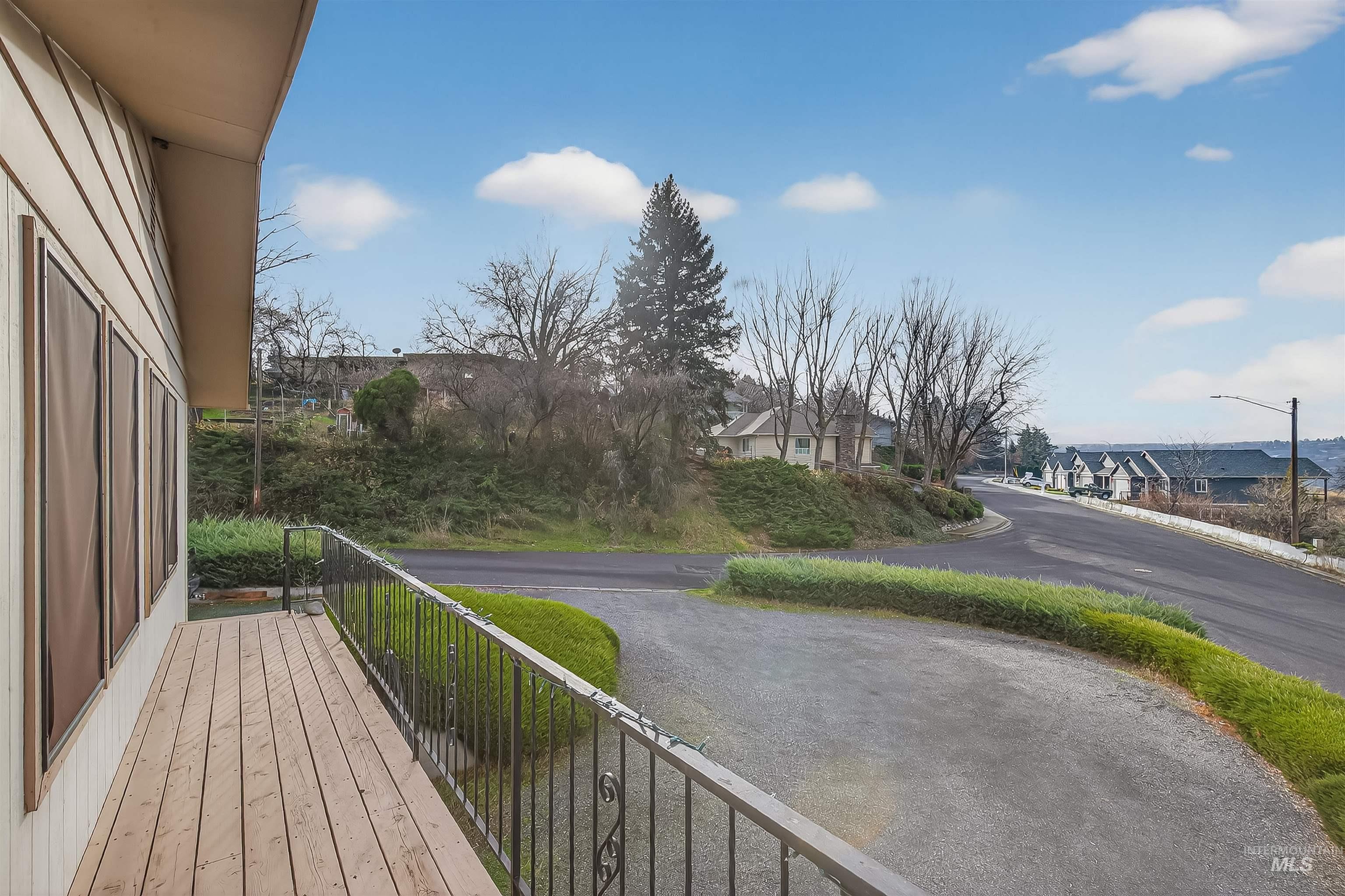 Wooden terrace featuring a residential view