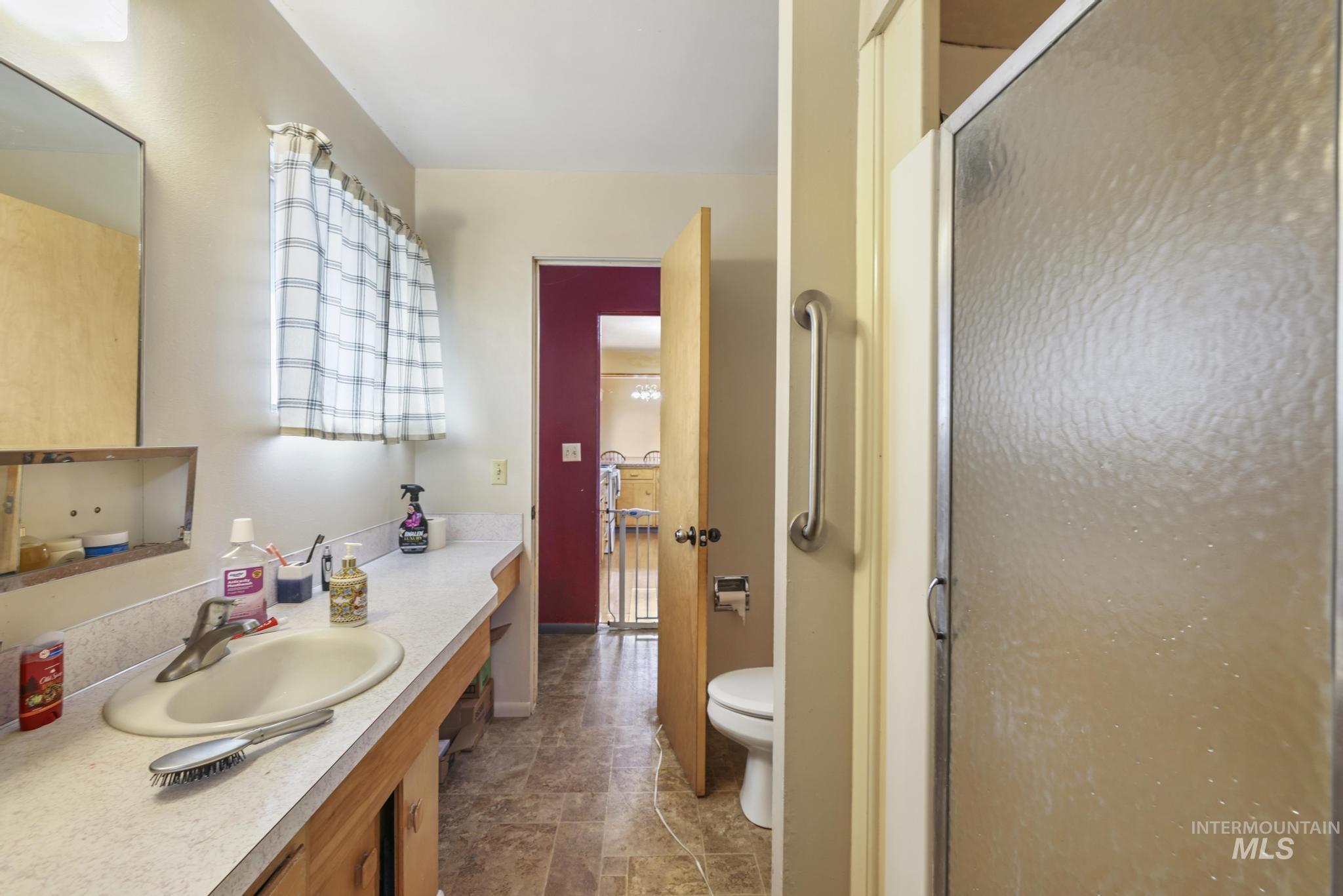 Bathroom featuring vanity and a stall shower
