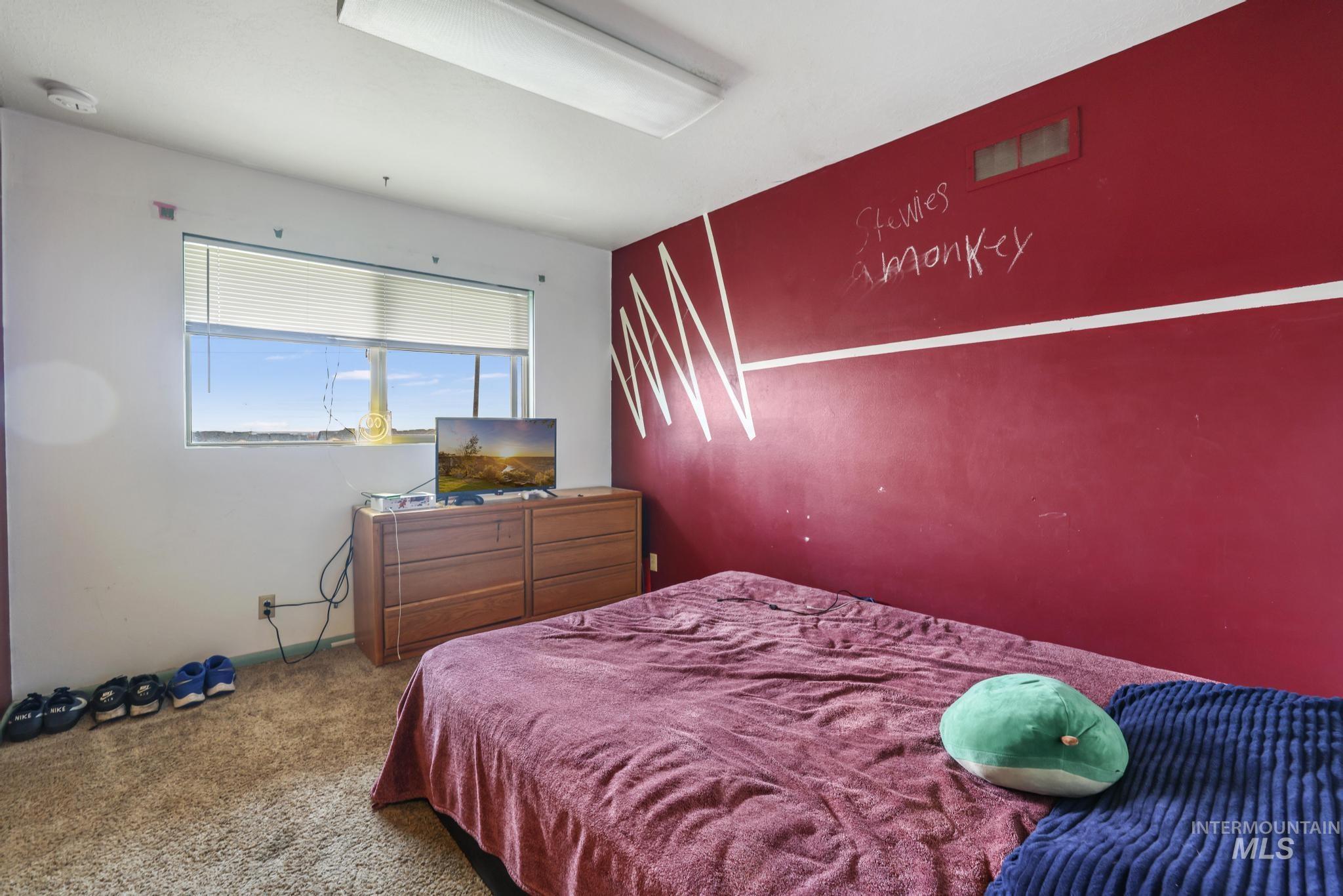 Bedroom with carpet flooring and baseboards