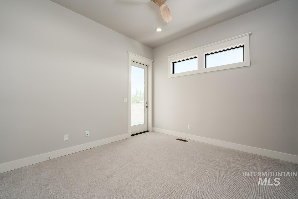 Carpeted spare room featuring recessed lighting and a ceiling fan
