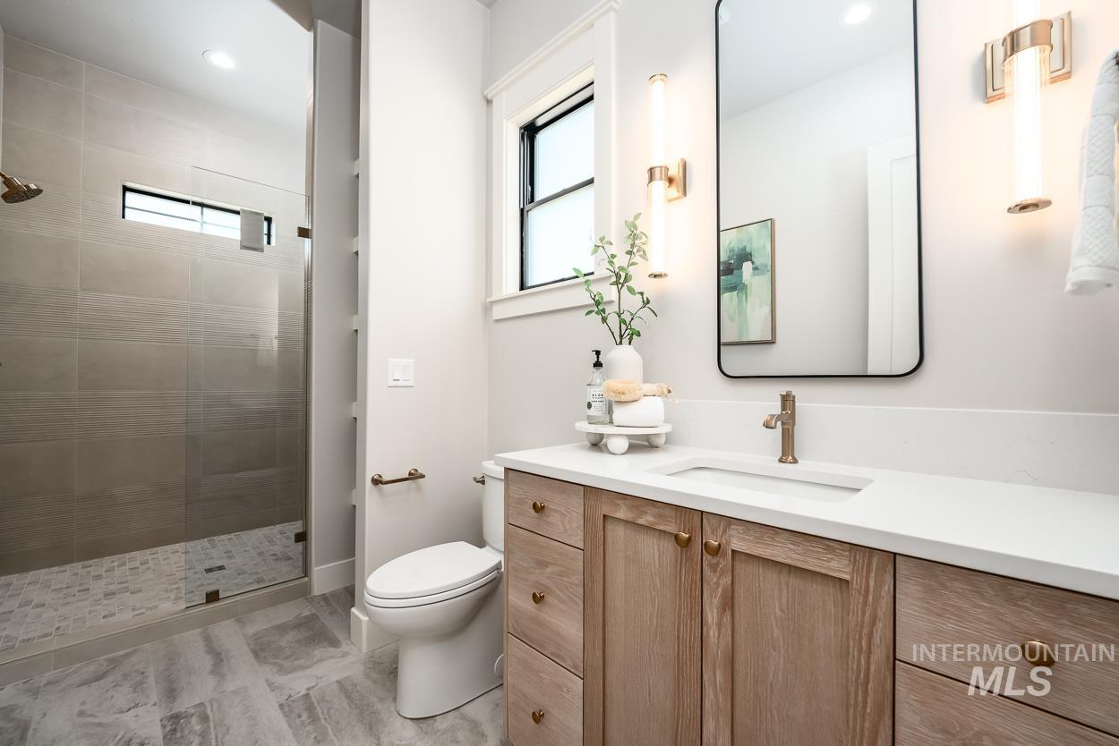 Full bathroom featuring vanity, walk in shower, and recessed lighting
