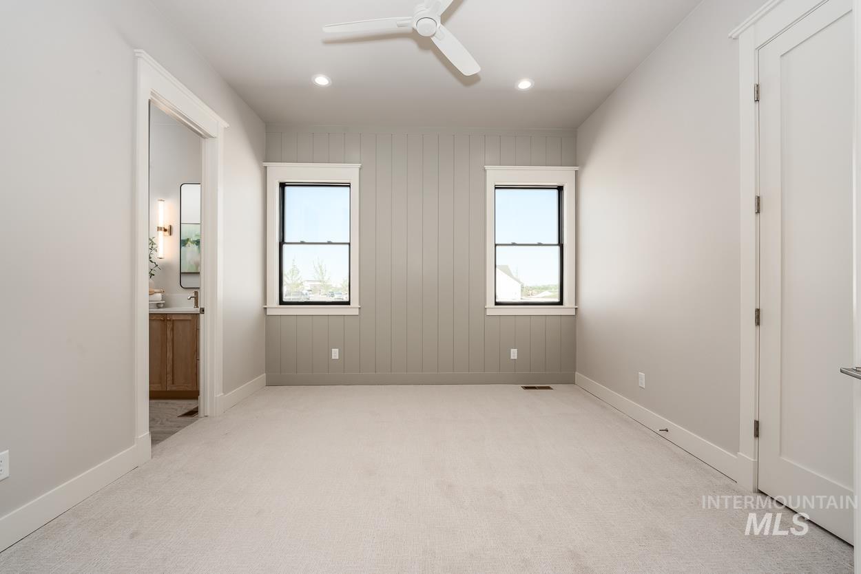 Unfurnished bedroom with carpet flooring, ceiling fan, recessed lighting, and connected bathroom