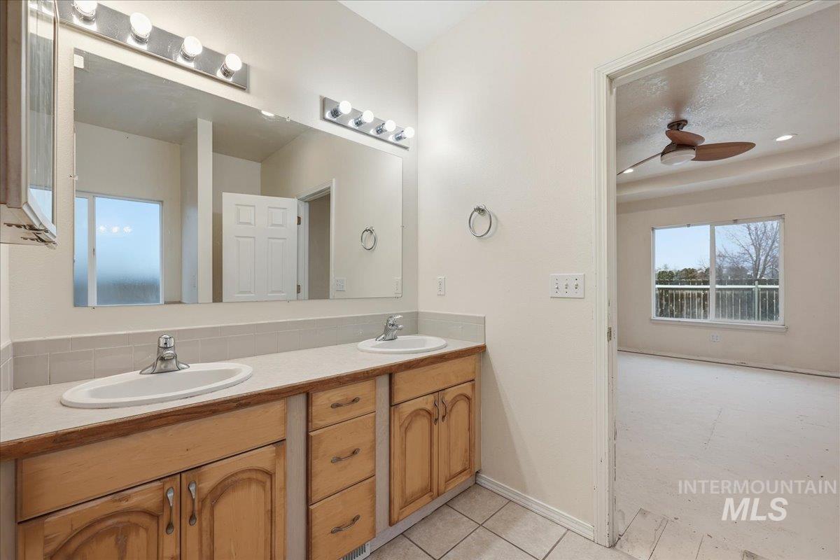 Master bathroom with double vanity, separate shower and jetted tub.