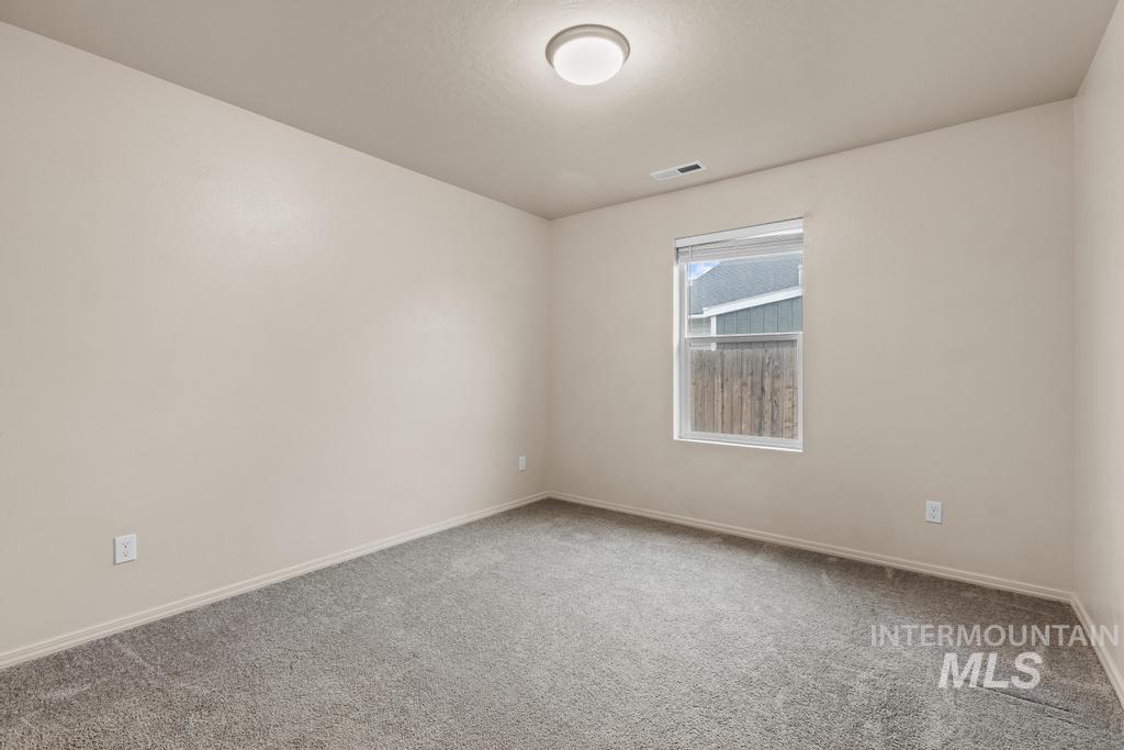 Empty room with carpet and baseboards