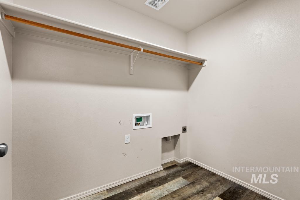 Washroom featuring dark wood-style flooring, electric dryer hookup, and washer hookup