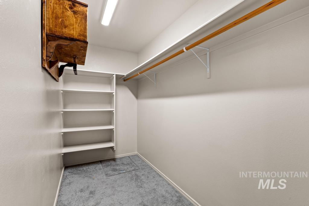 Spacious closet with light carpet