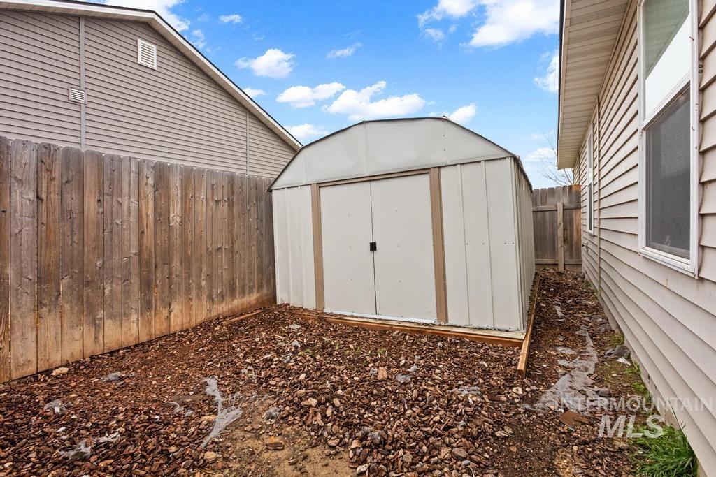 View of shed featuring a fenced backyard