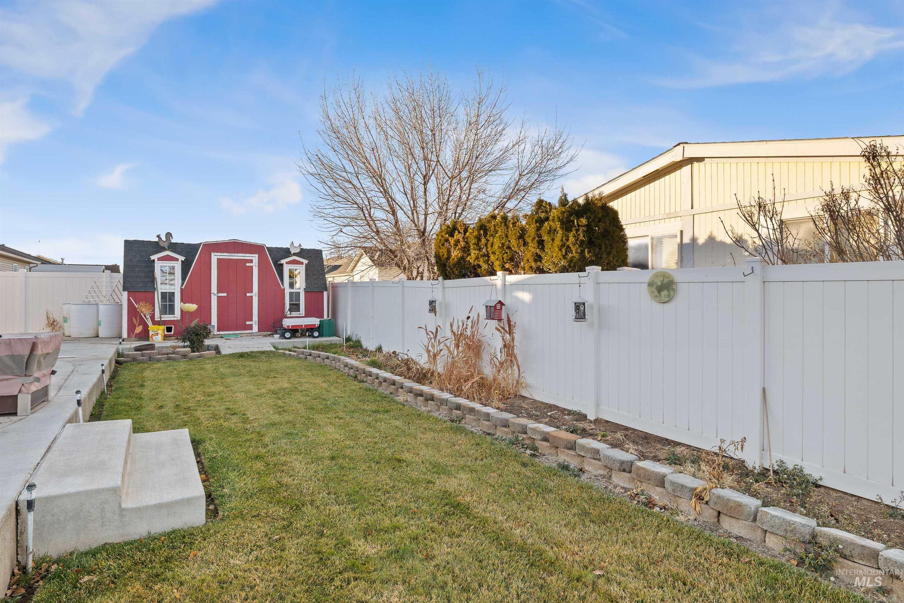 Fenced backyard with a shed