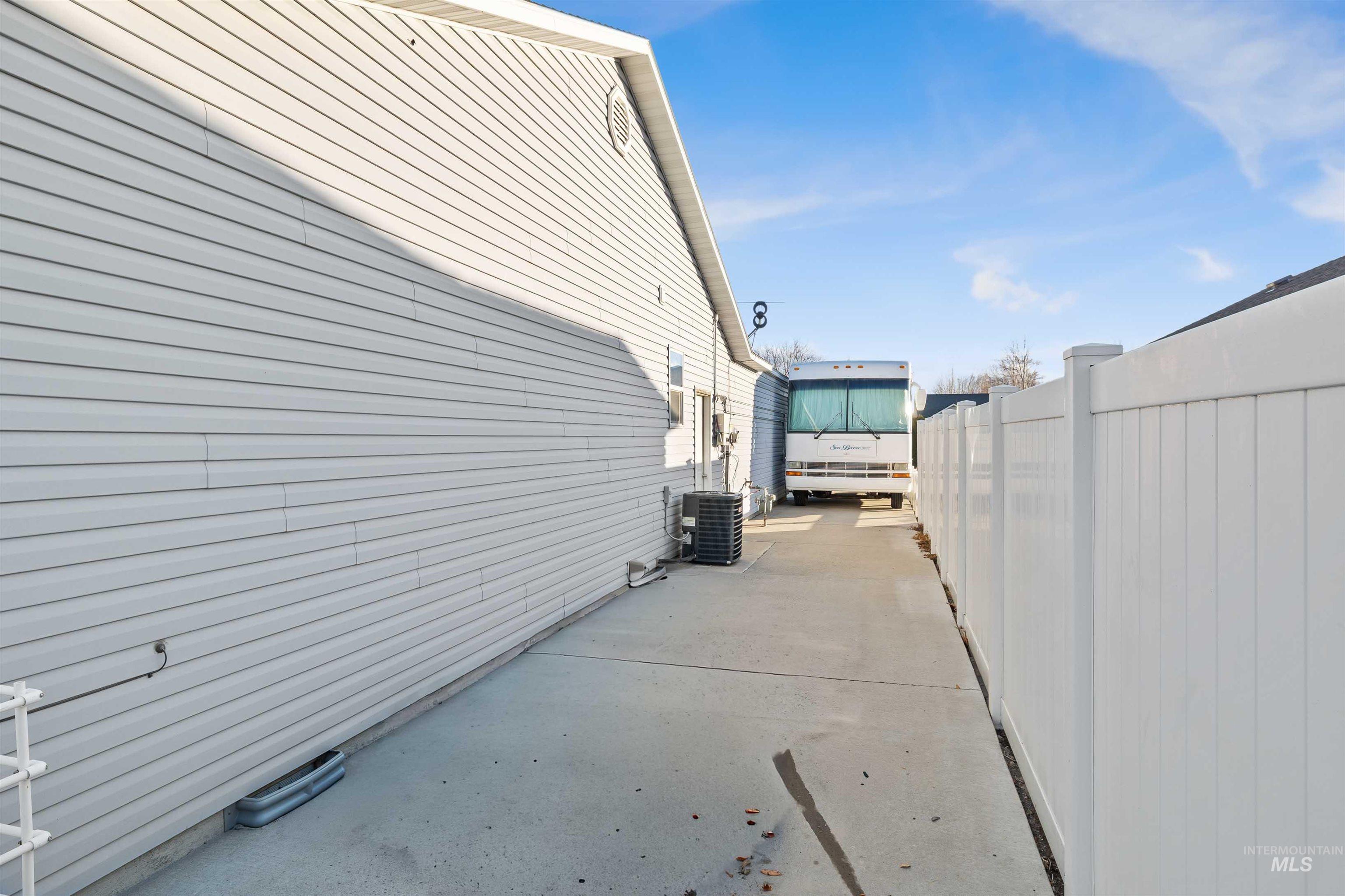 View of property exterior featuring a central AC unit