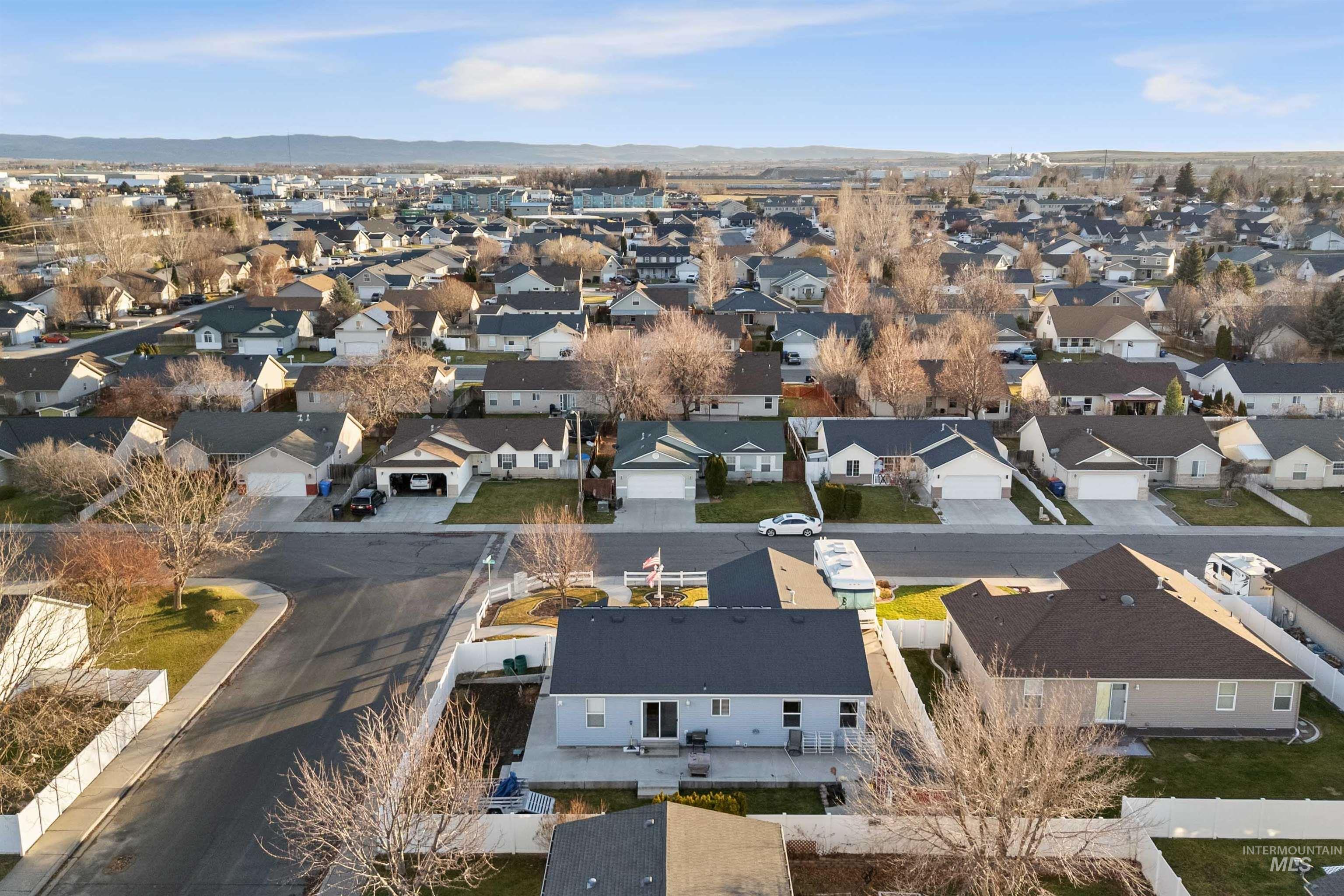 Aerial view of residential area featuring mountains