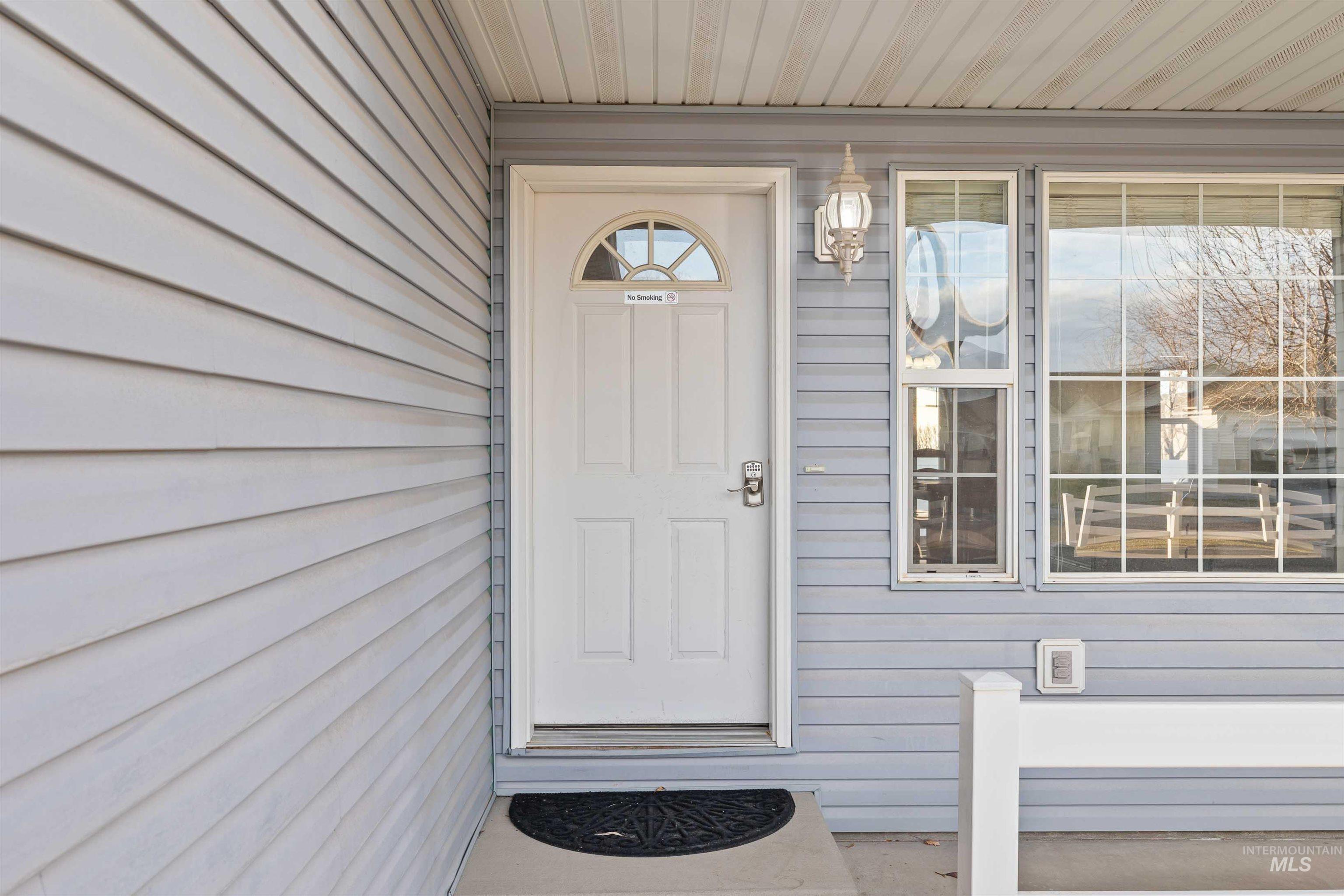 View of exterior entry featuring a porch