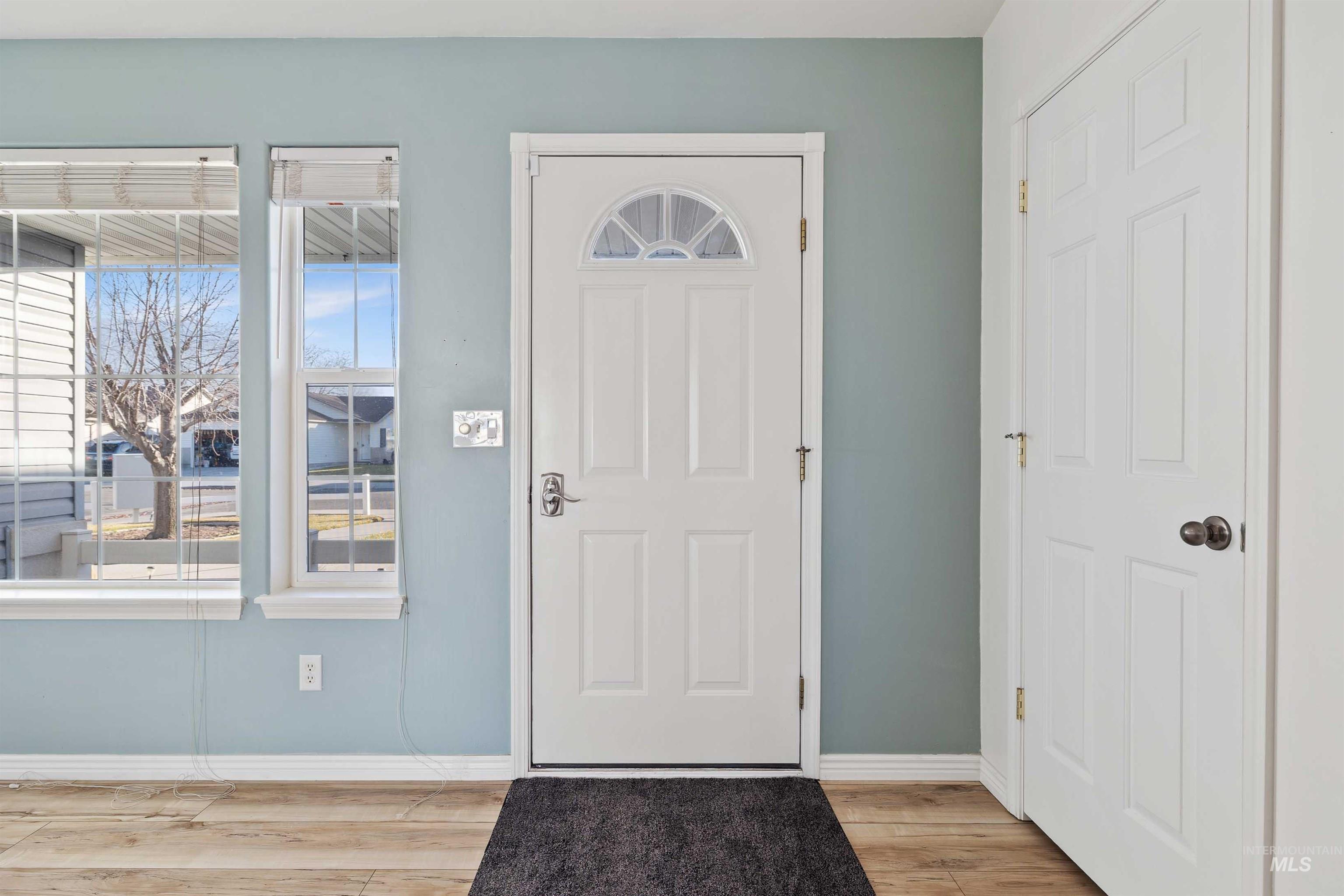 Entryway featuring light wood-type flooring and baseboards