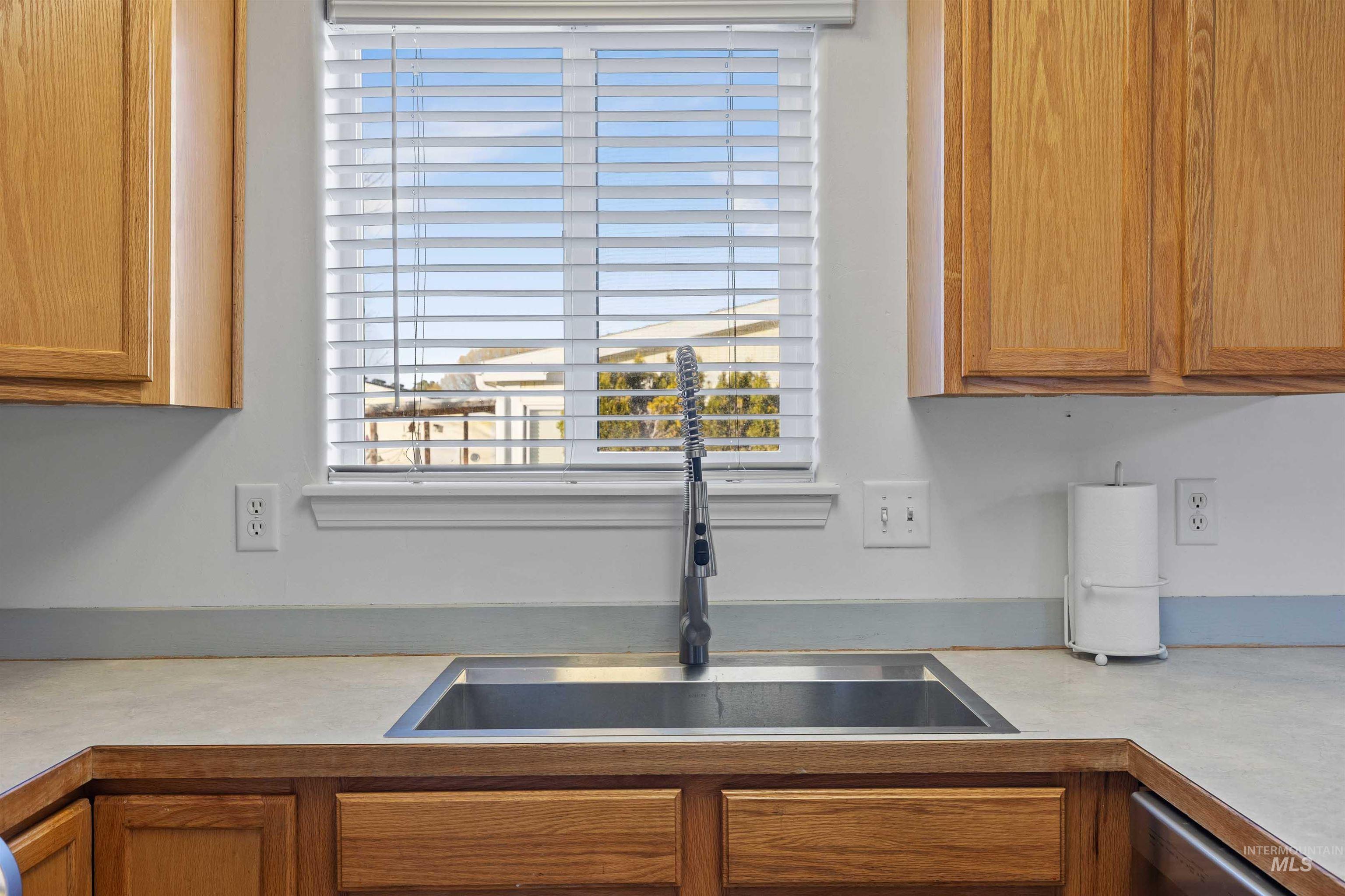 Kitchen featuring light countertops and brown cabinets