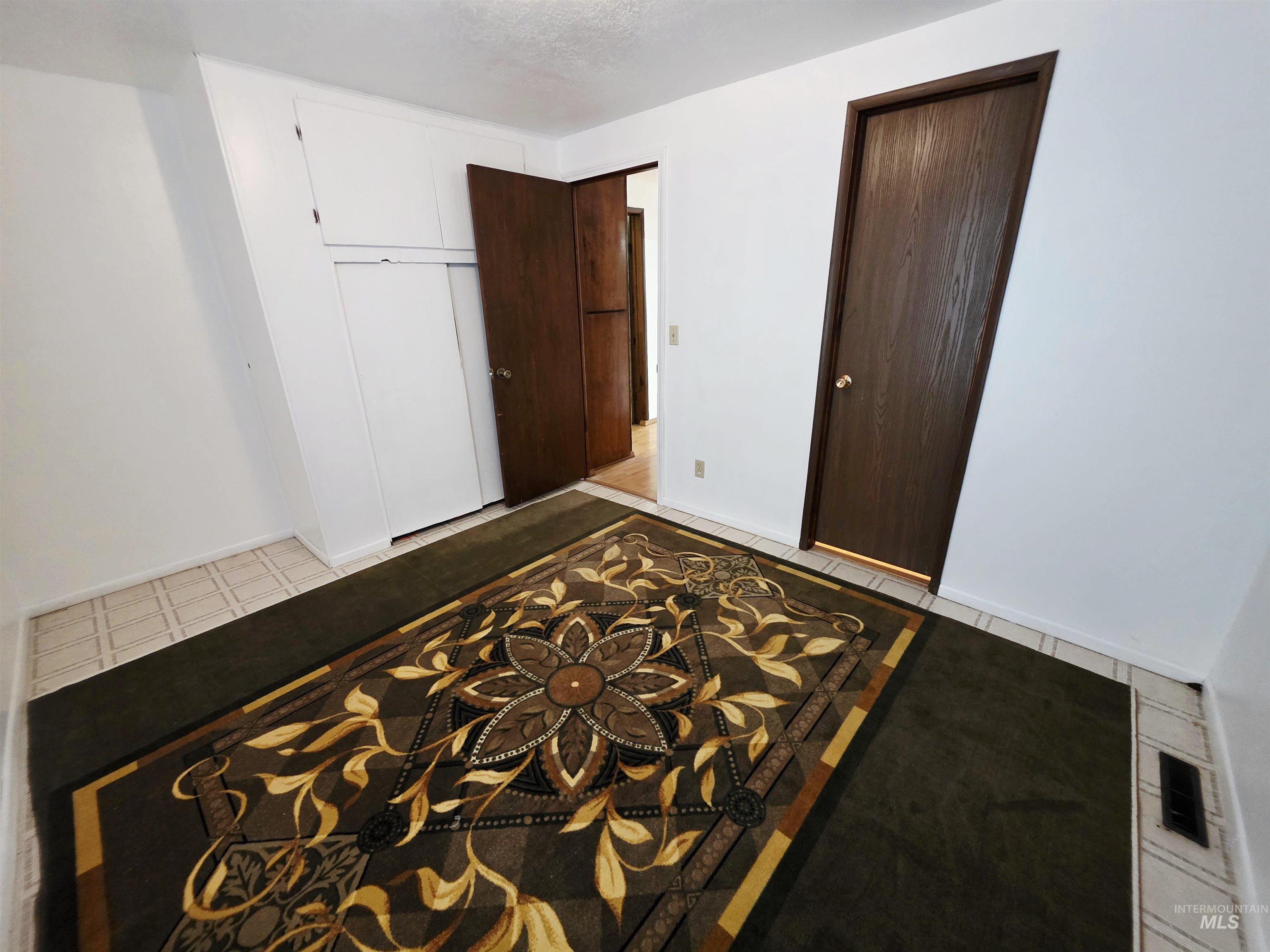 Unfurnished bedroom with a closet and baseboards