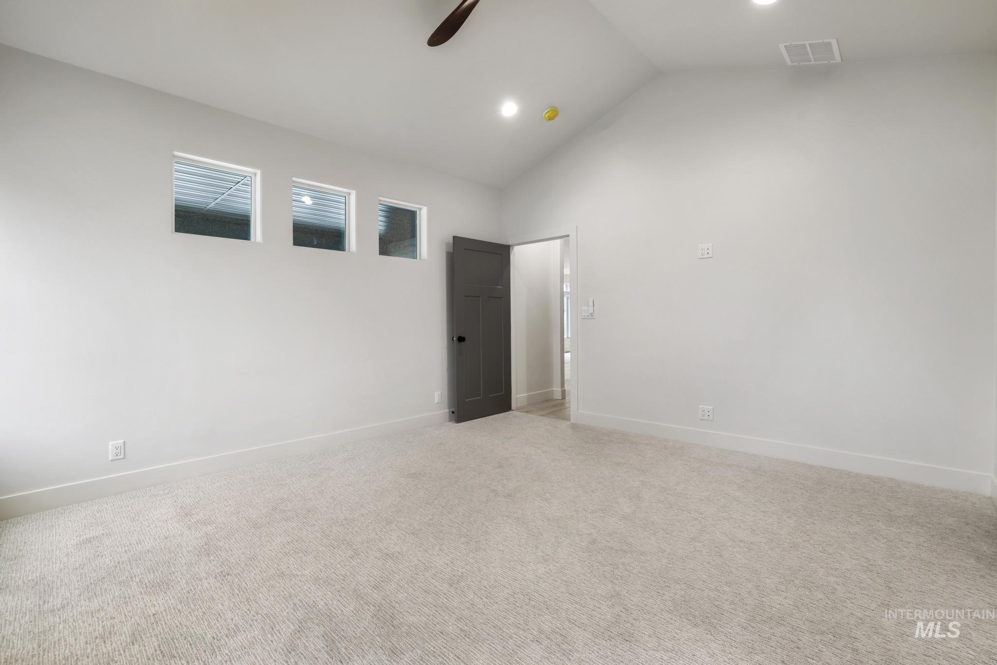 Unfurnished room with light colored carpet, a ceiling fan, high vaulted ceiling, and recessed lighting