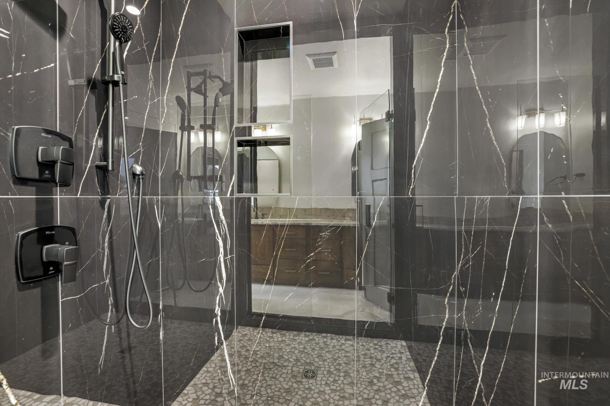 Bathroom featuring a marble finish shower