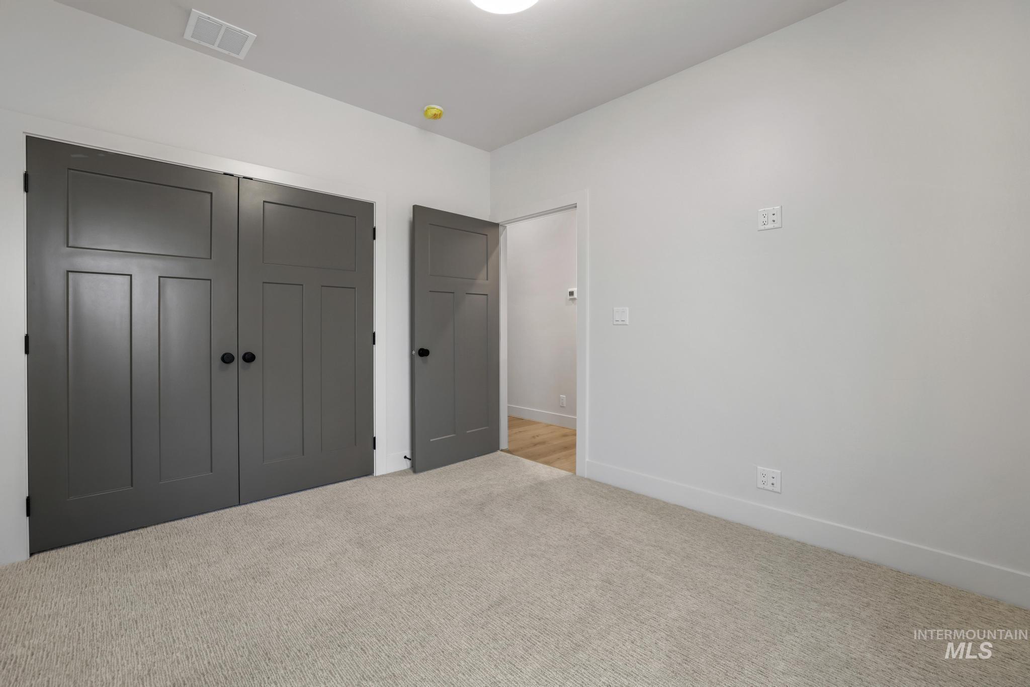 Unfurnished bedroom with a closet and carpet flooring