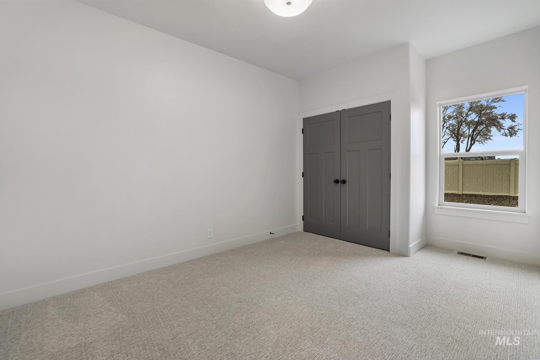 Unfurnished bedroom with carpet and a closet